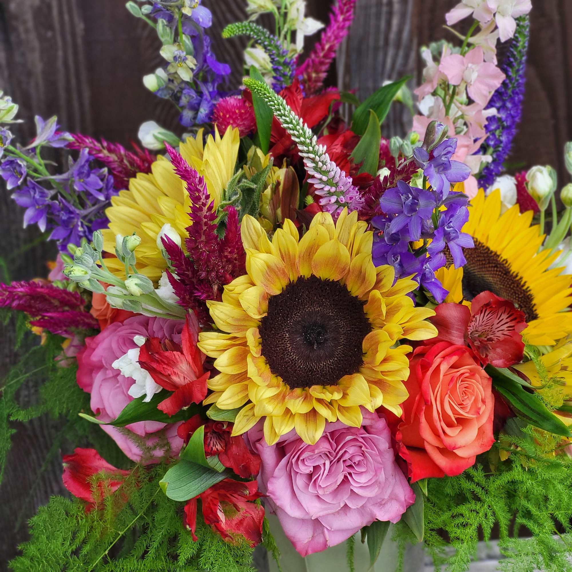 Colorful bouquet with sunflowers, roses, and purple flowers