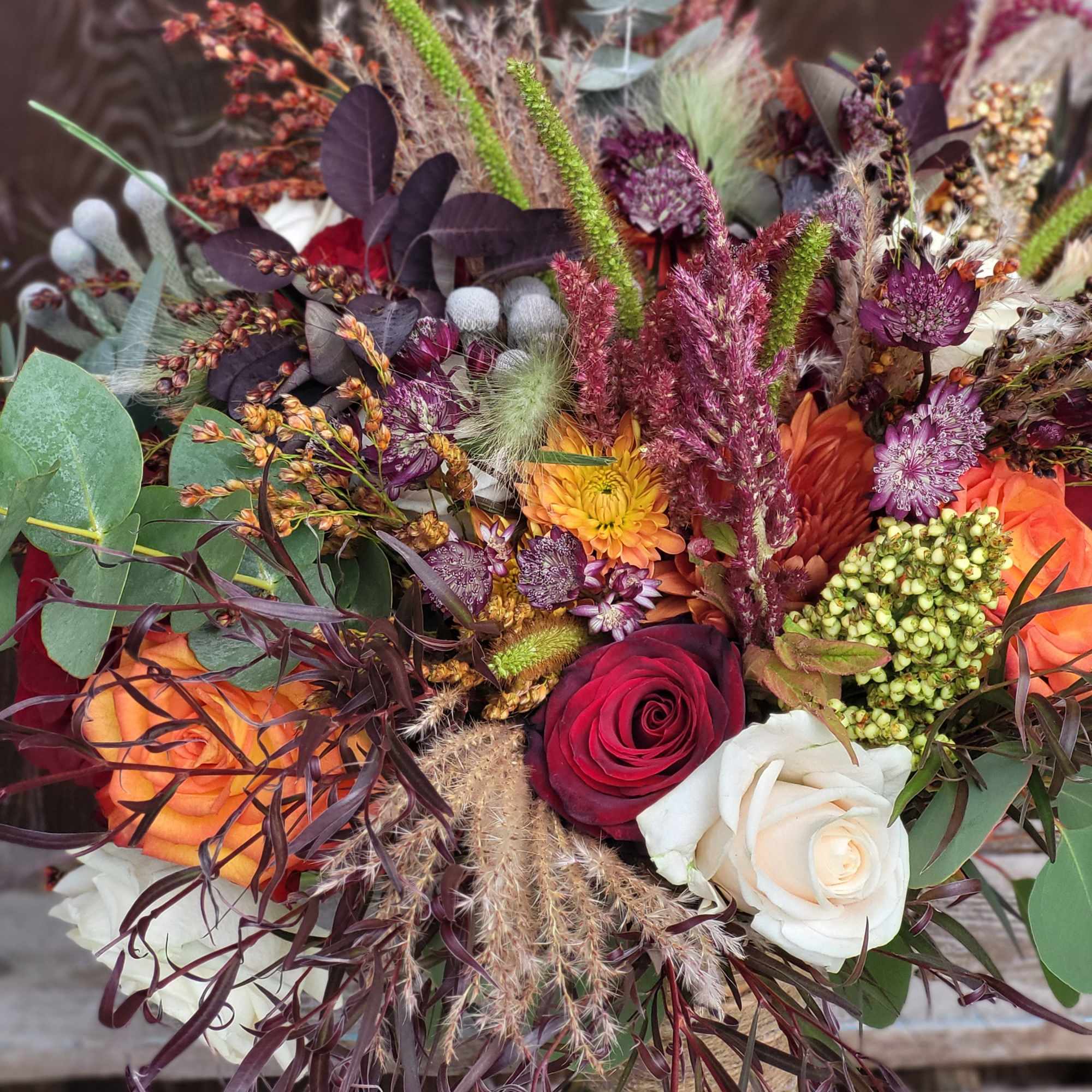 Mixed bouquet with roses and dried flowers in autumn colors