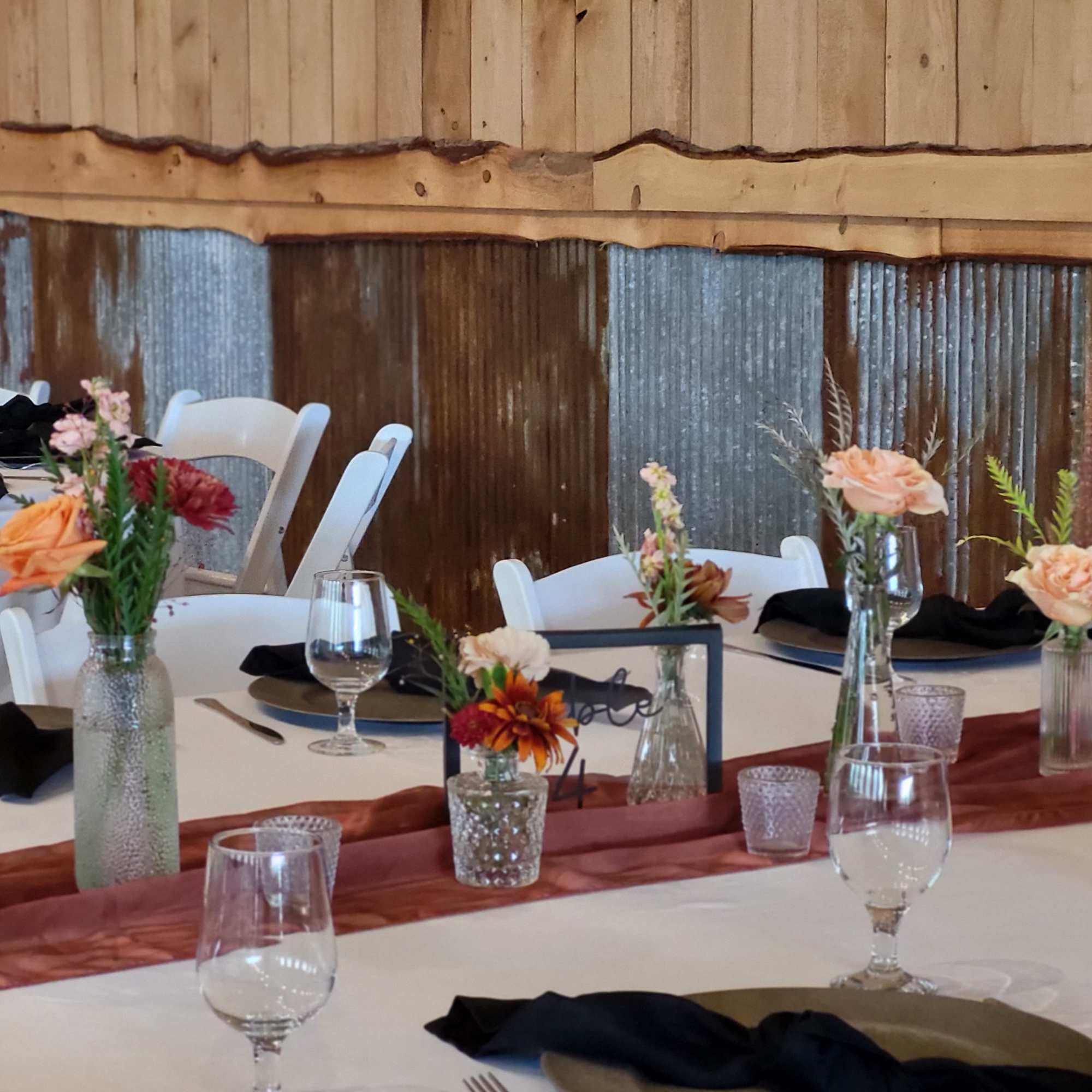 Small floral centerpieces on decorated banquet tables