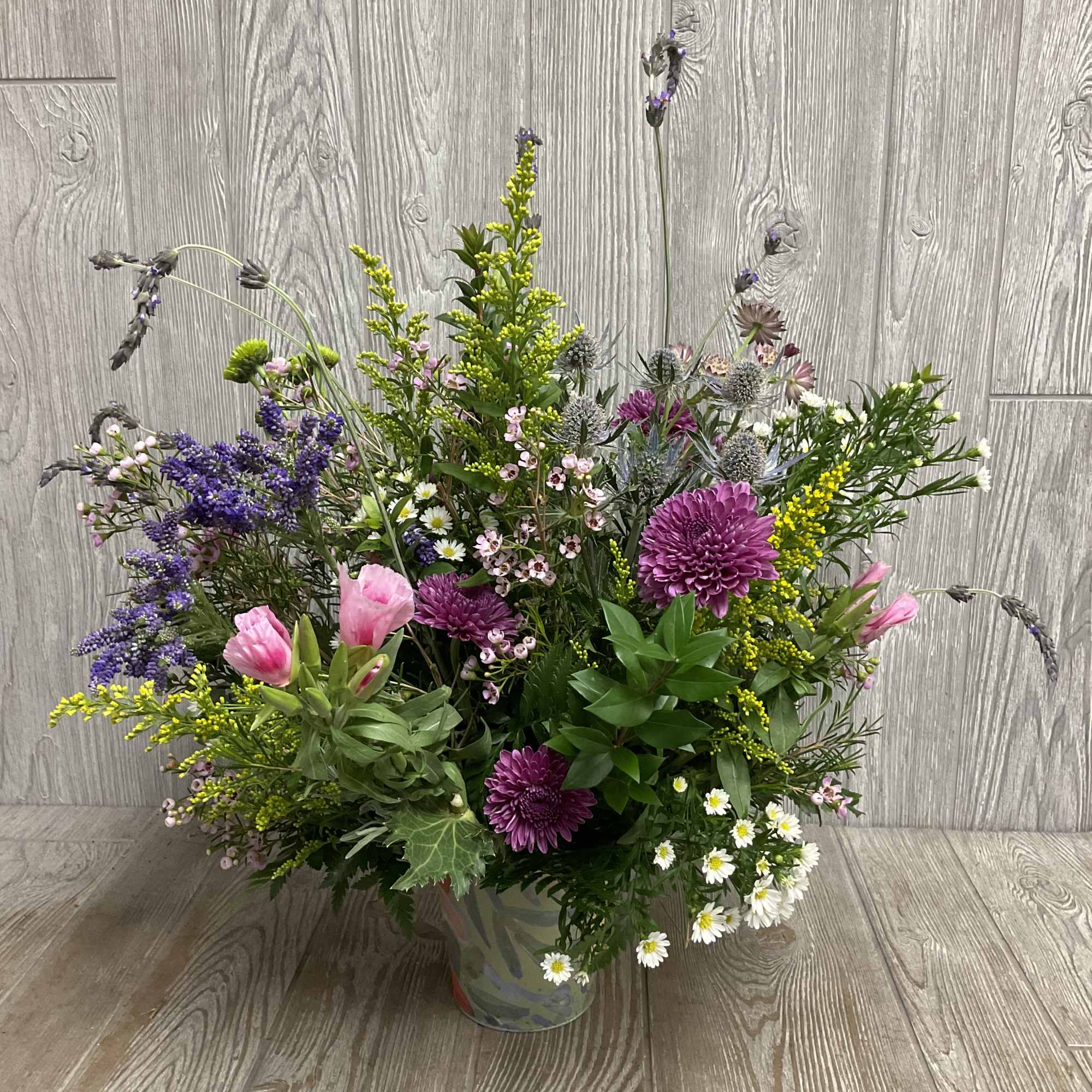 Mixed bouquet in a glass vase with purple, pink, and white flowers