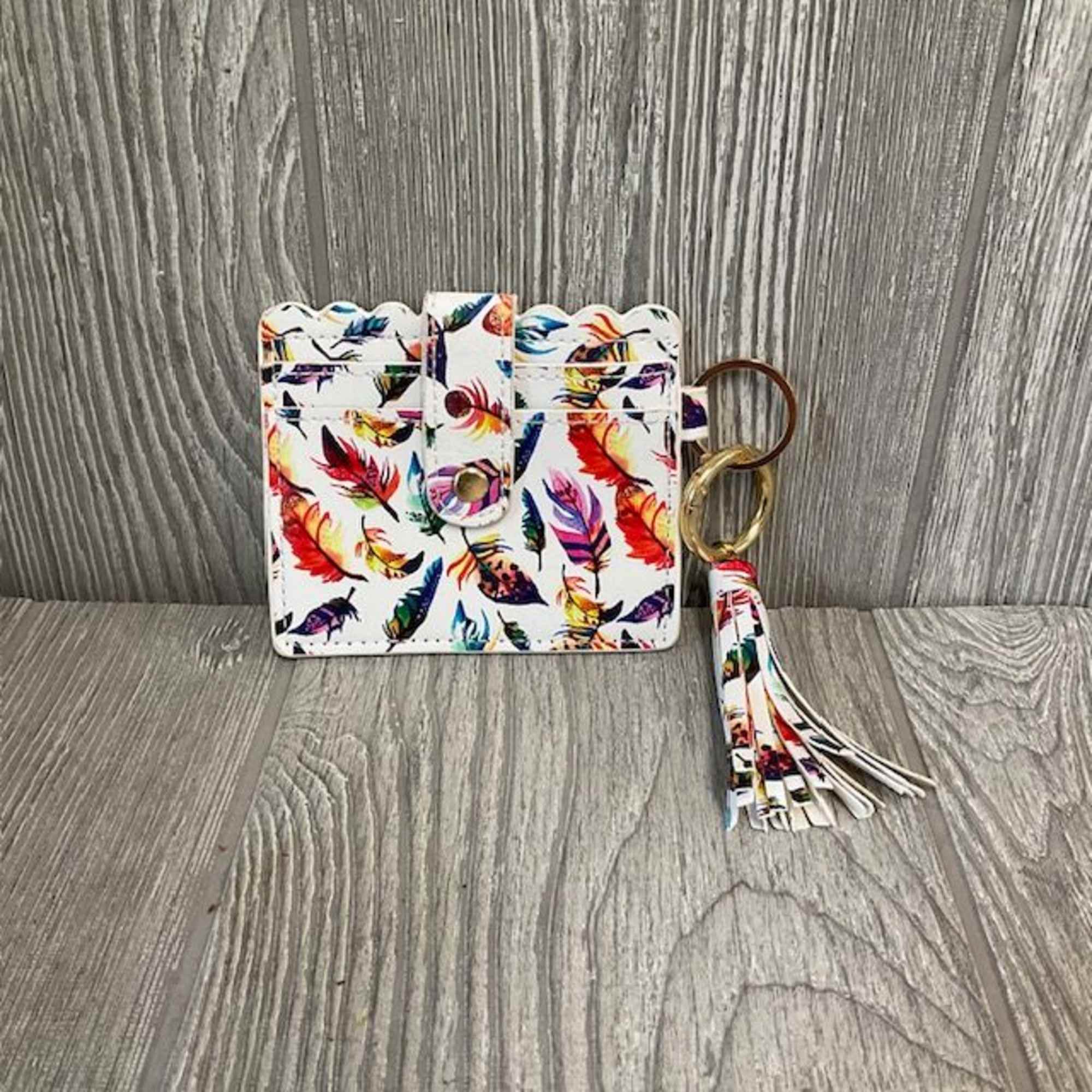 Feather-print card holder with a matching tassel keychain