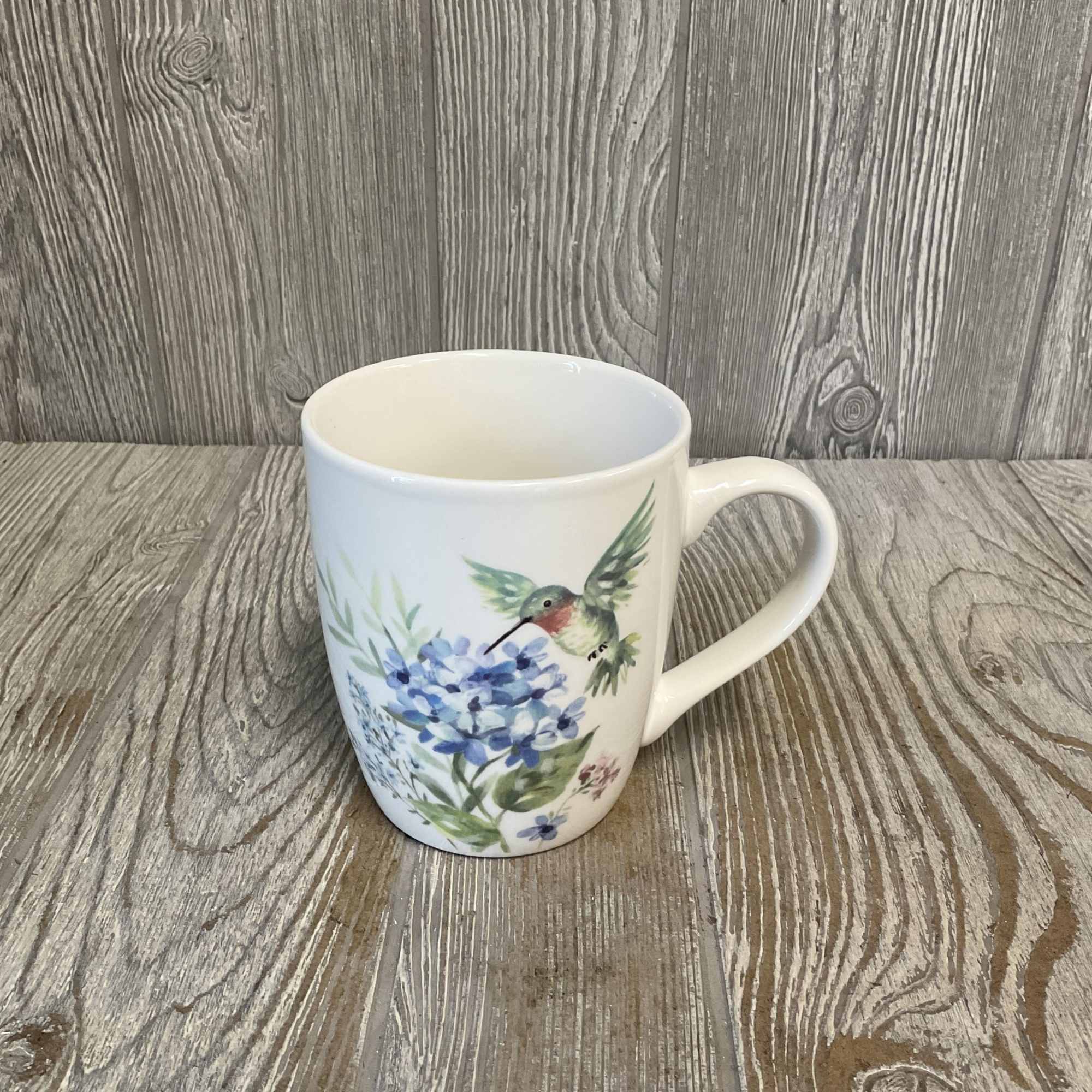 White mug with a hummingbird and blue floral design