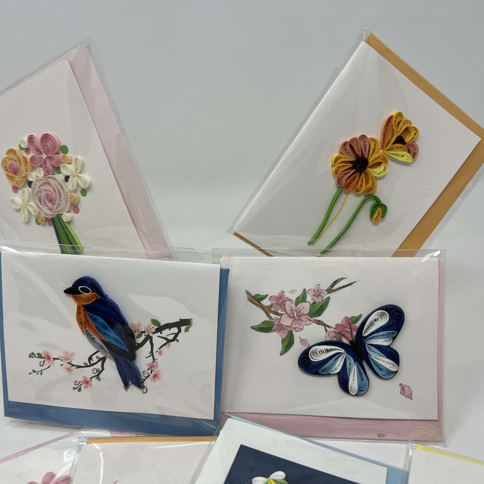 Decorative greeting cards with quilled flower and bird designs