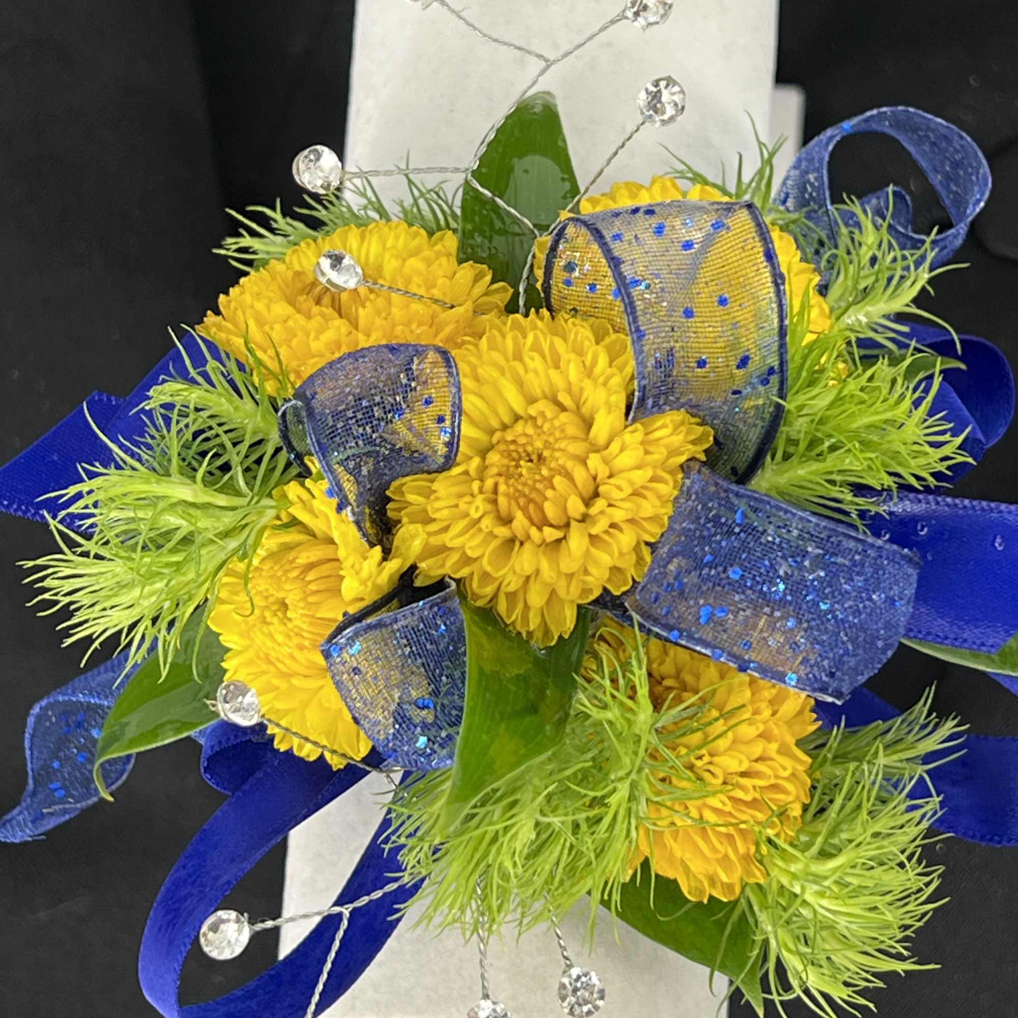 Yellow chrysanthemum corsage with blue ribbon and crystal accents