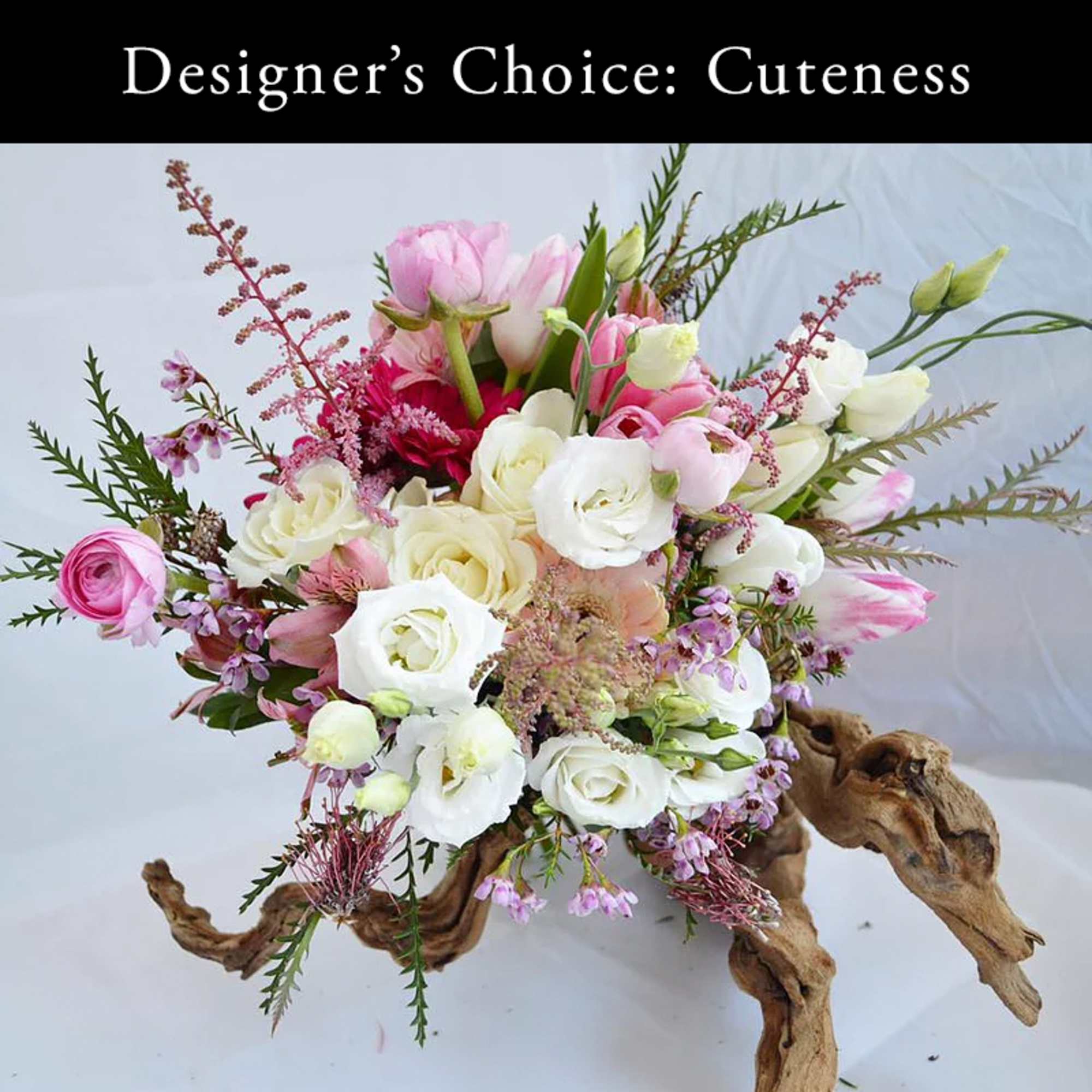 Pink and white mixed bouquet arranged on a driftwood base