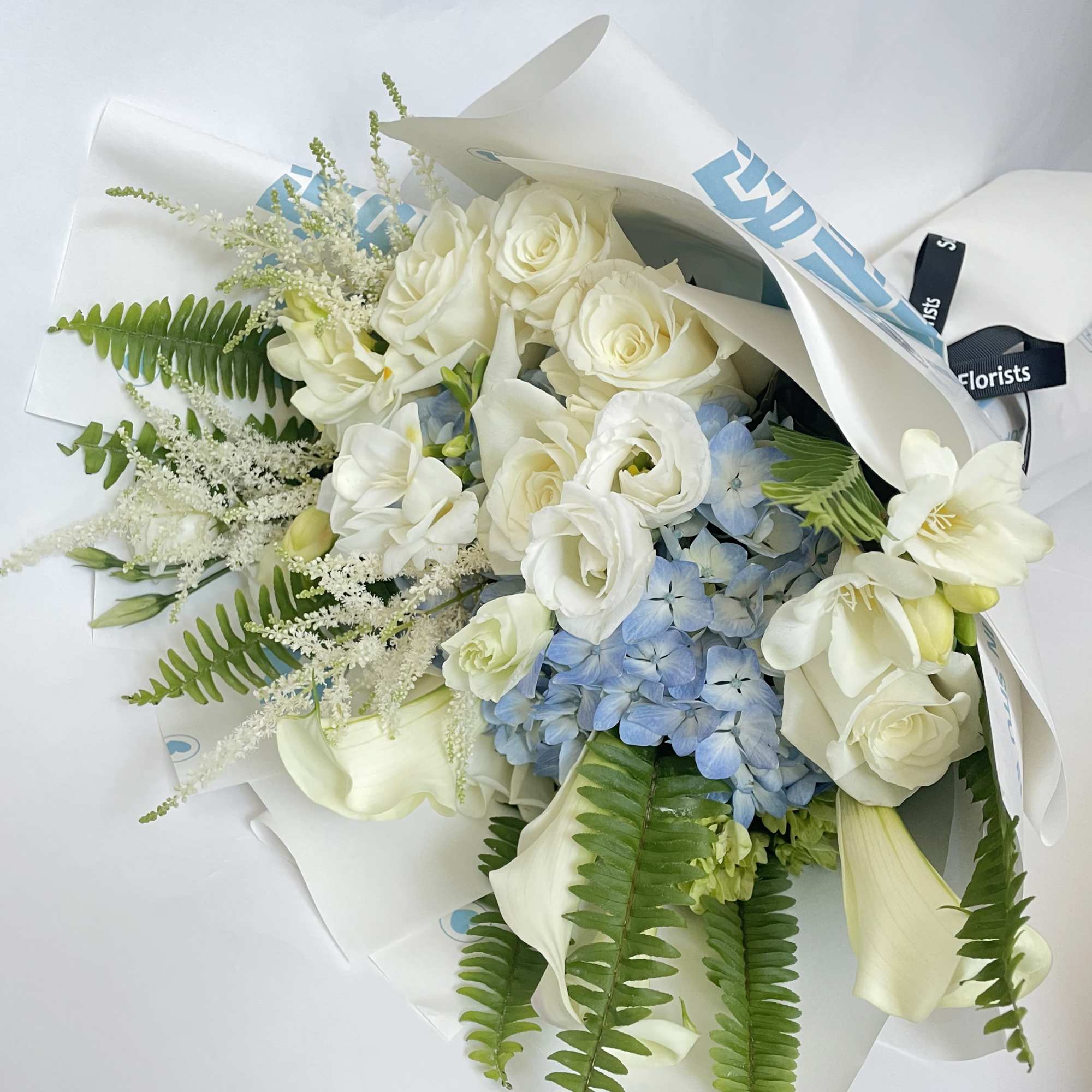 This bouquet features white and soft blue colors. , photo 2 of 3