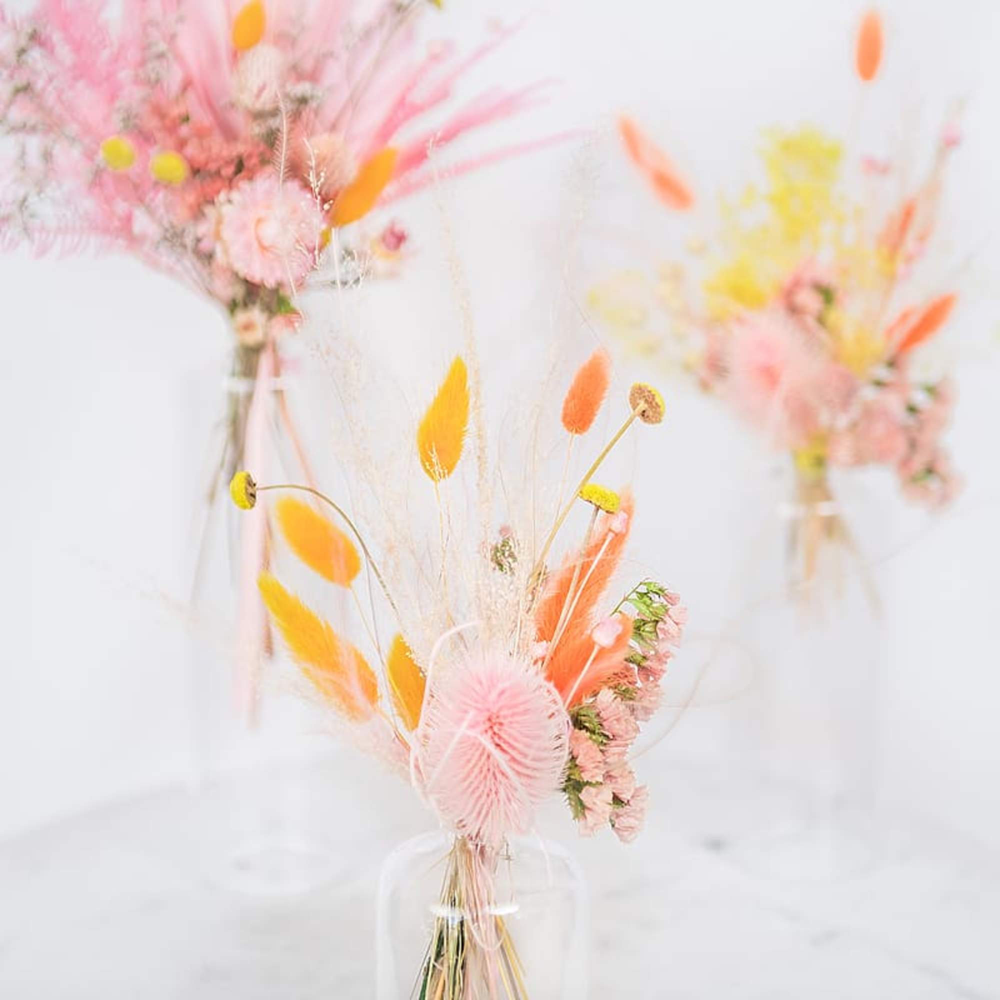 Pastel dried flower arrangement in a clear vase