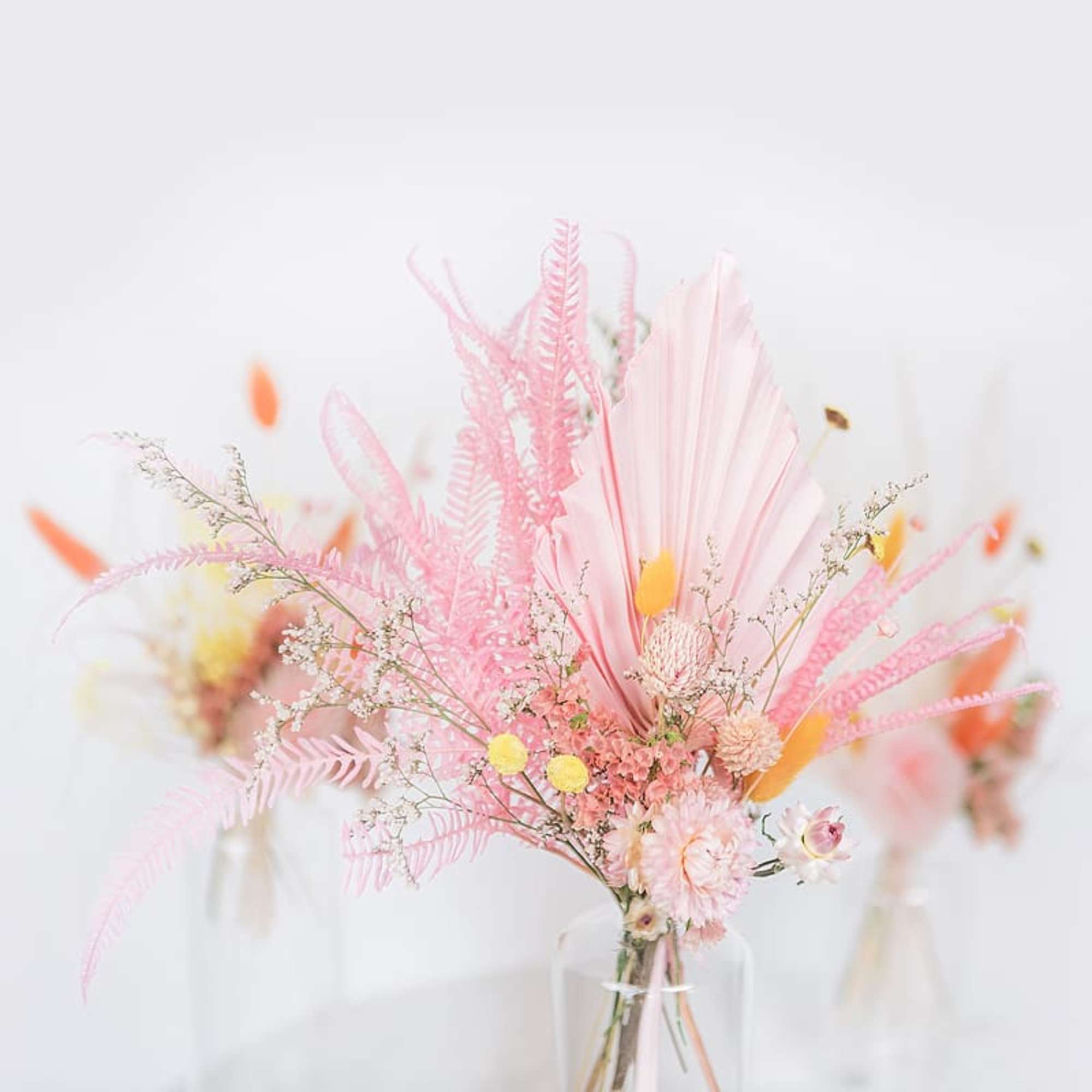 Pink and peach floral arrangement in a clear vase