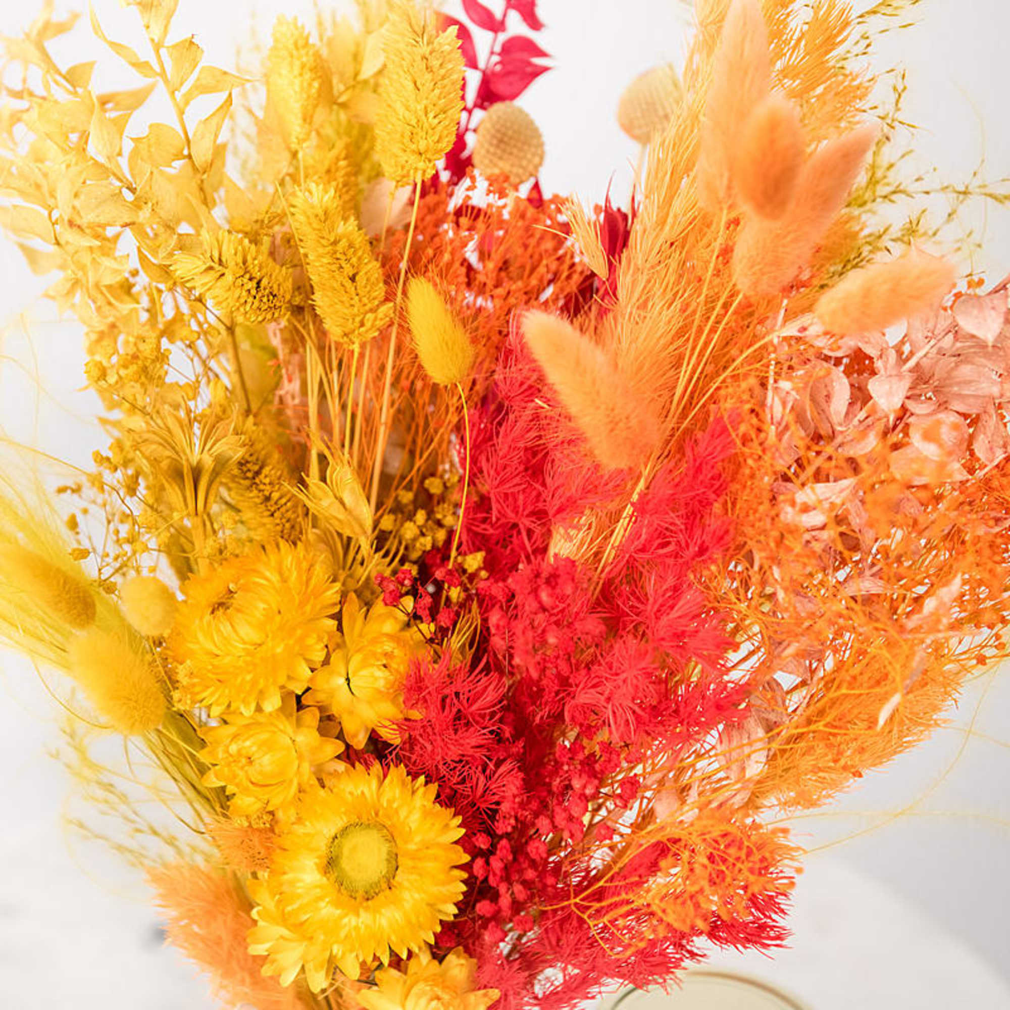 Bright dried bouquet with yellow, orange, and red flowers