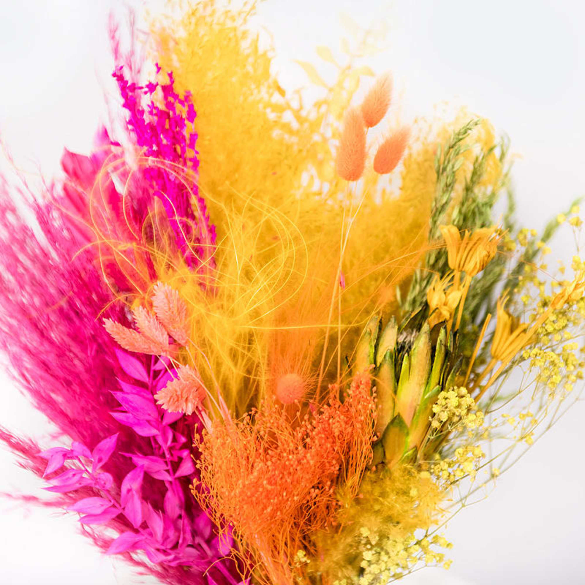 Bright dried floral arrangement in pink, orange, yellow, and green tones