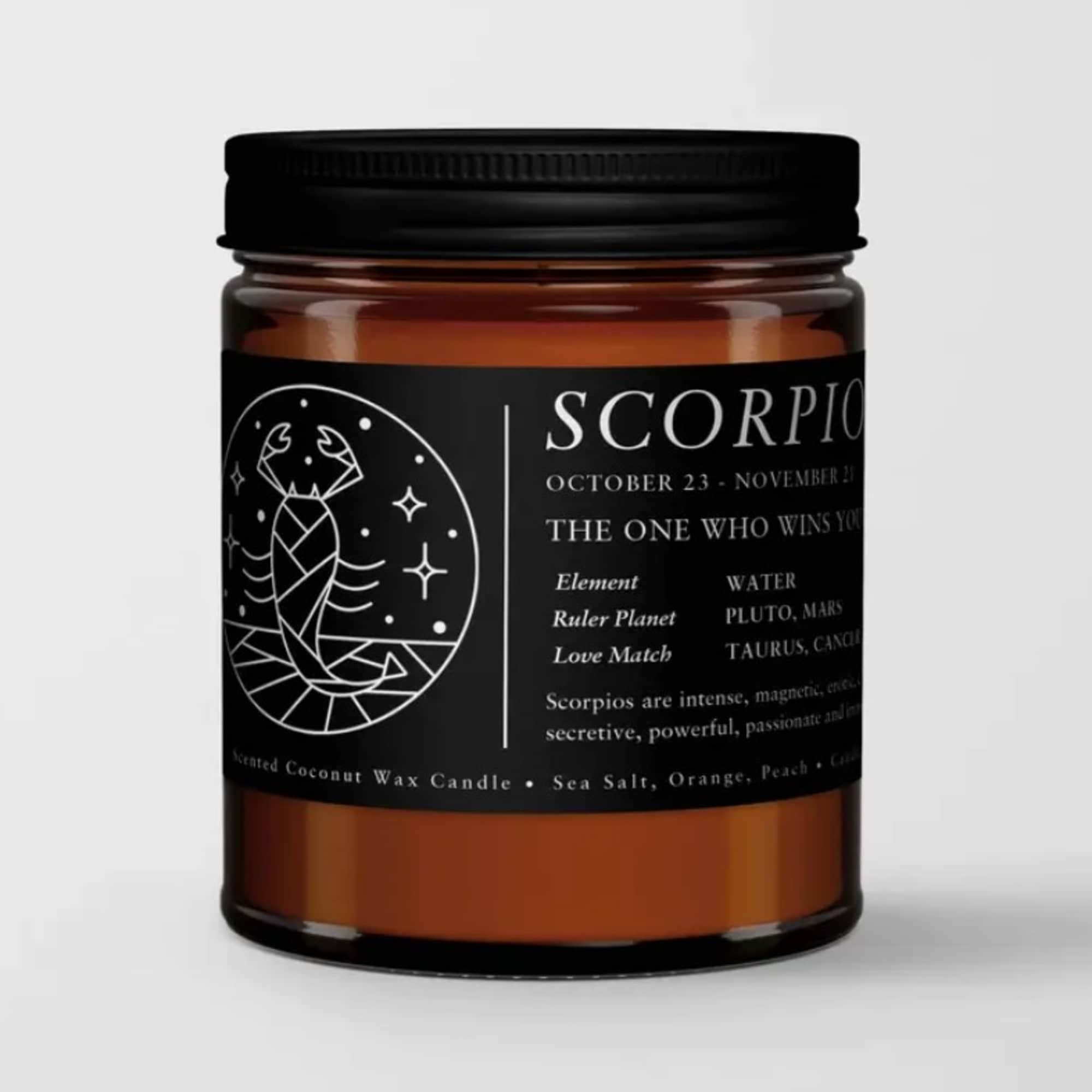 Amber jar candle with a black label and Scorpio graphic