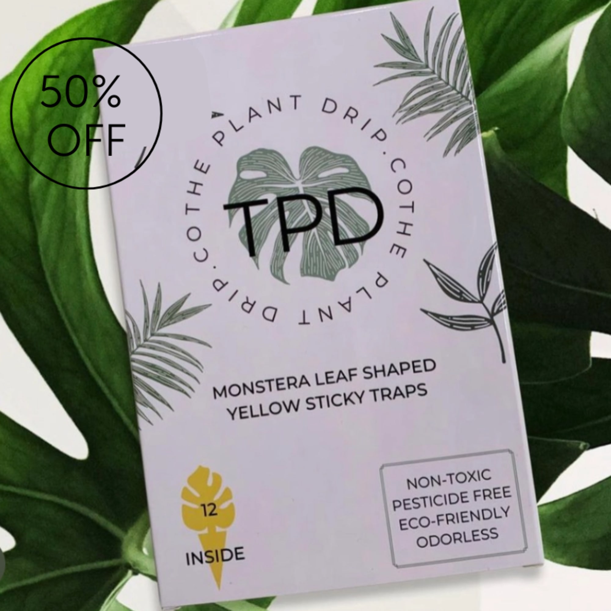 Package of monstera-shaped yellow sticky traps on large green leaves