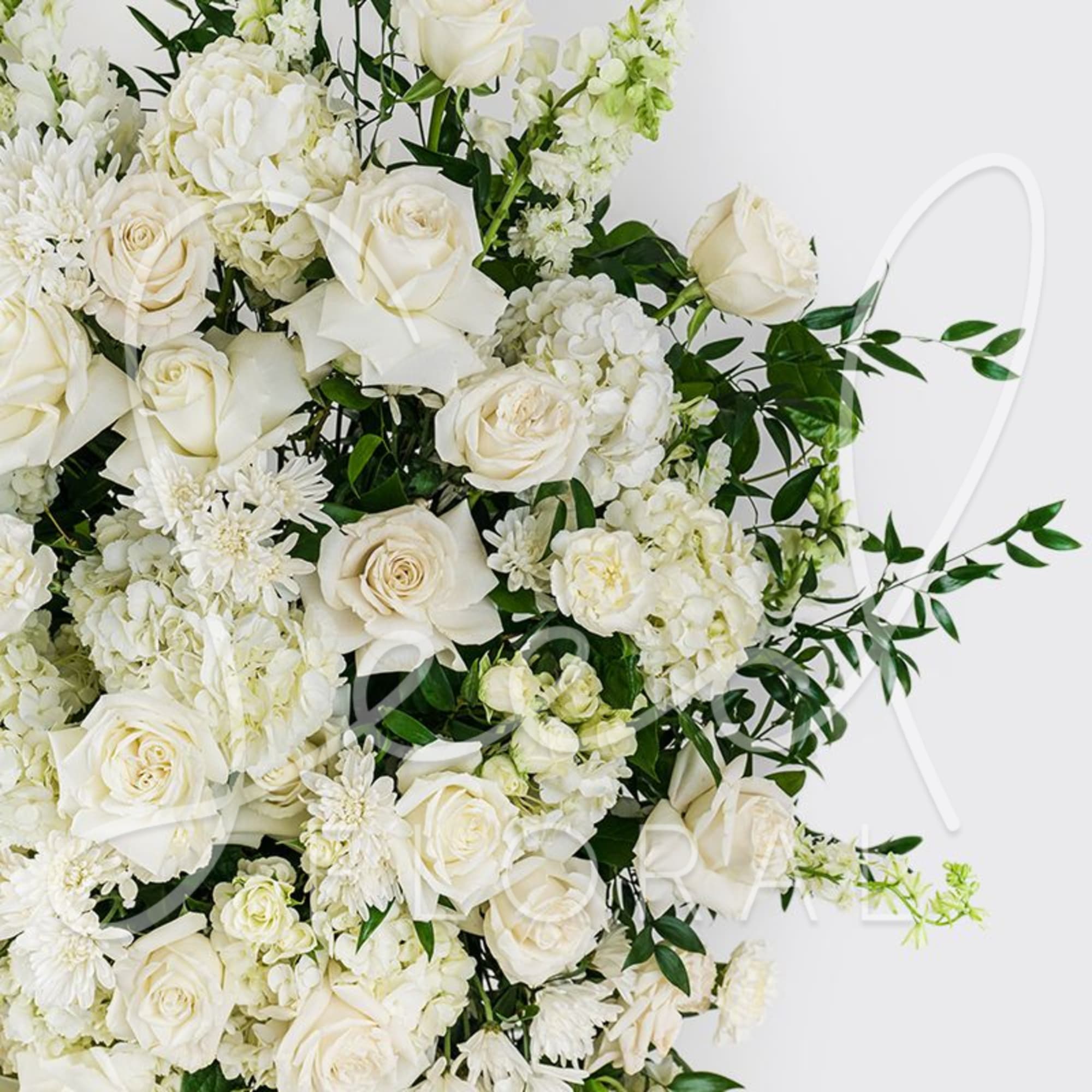White rose and chrysanthemum bouquet with green foliage