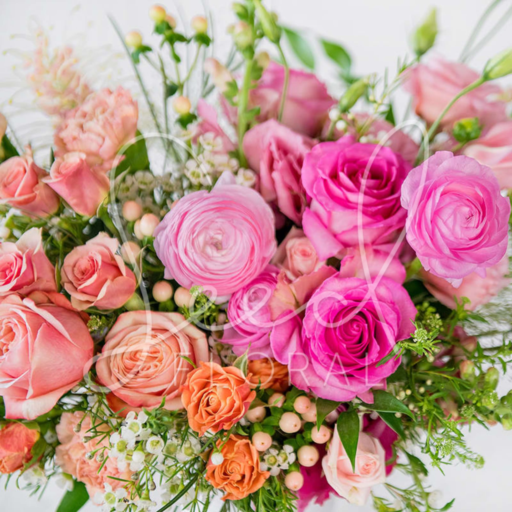Pink and peach bouquet of roses and ranunculus