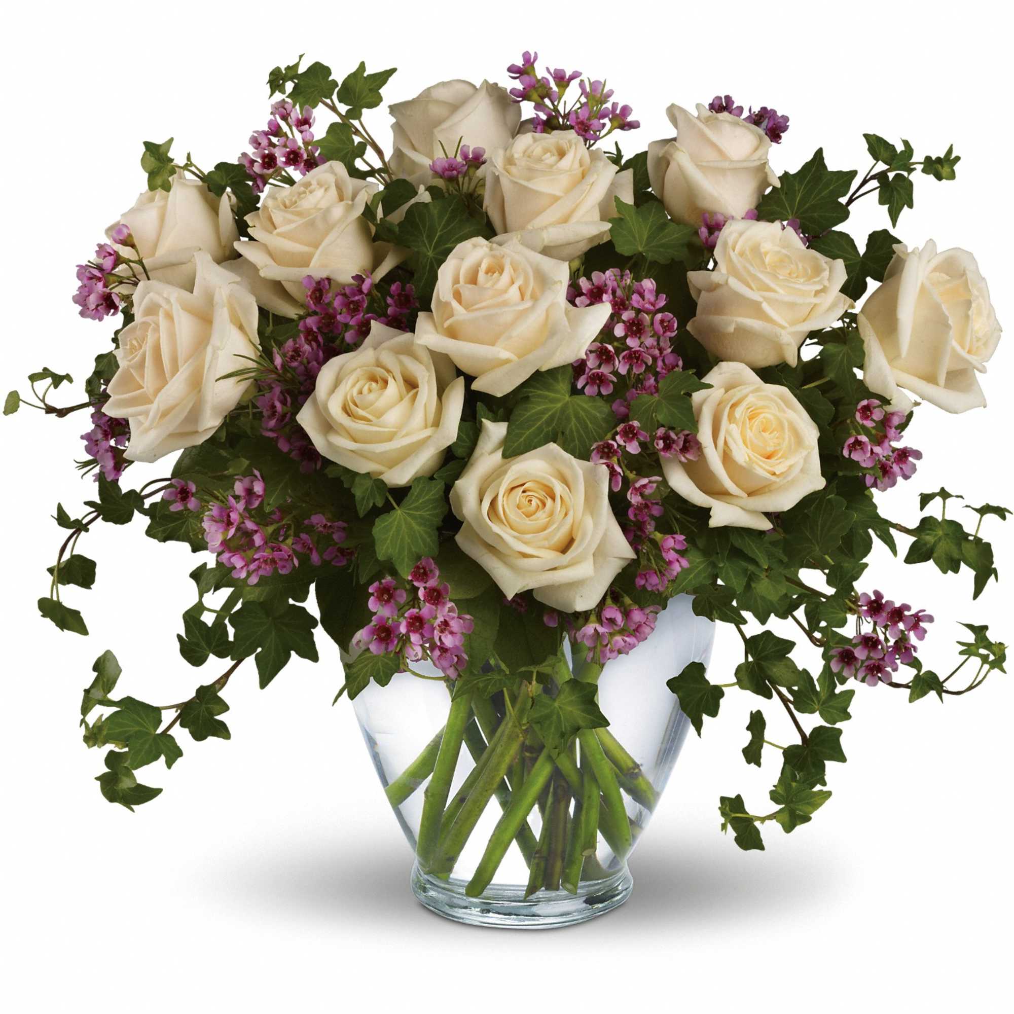 Cream roses and purple filler flowers in a clear glass vase