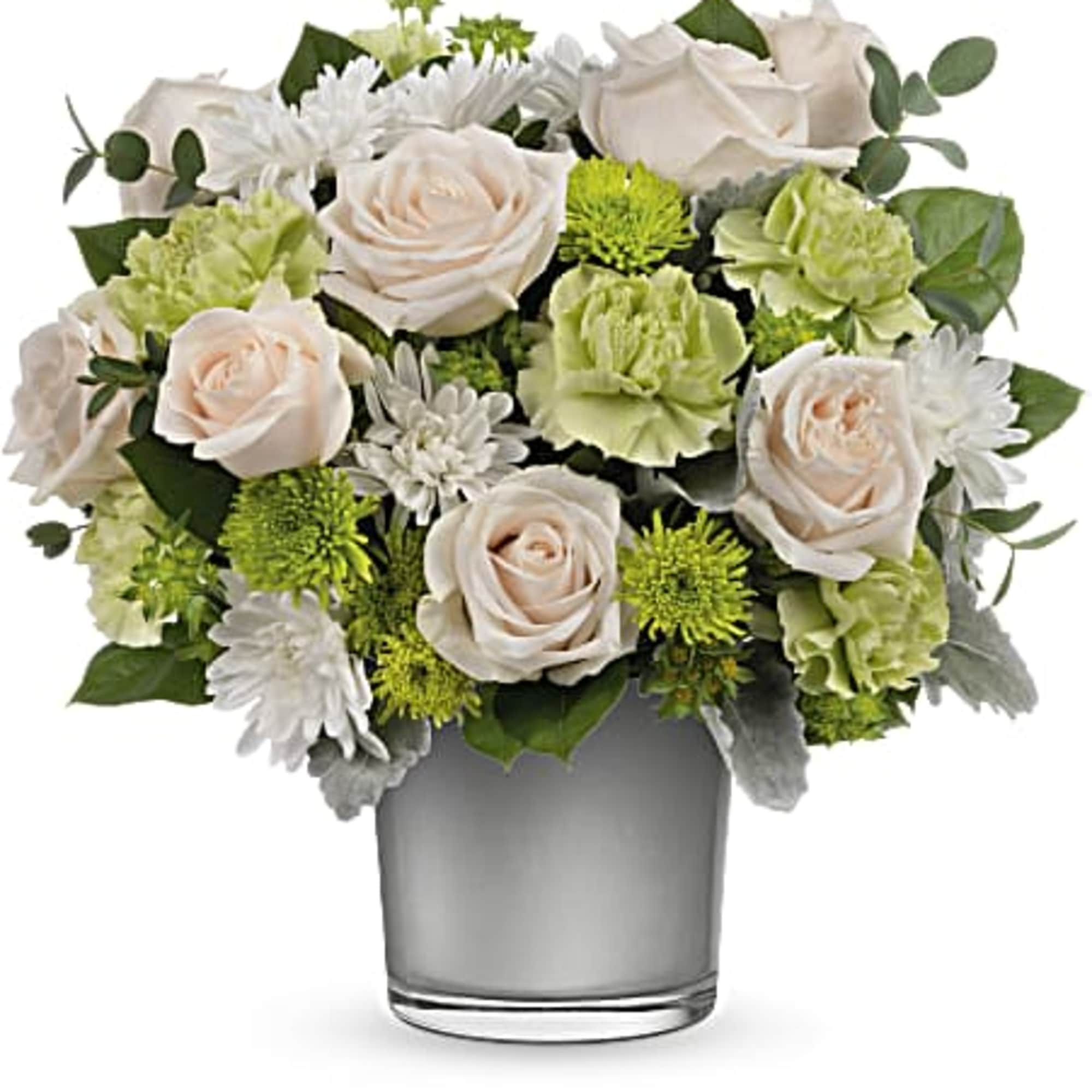 Bouquet of pale roses, white daisies, and green blooms in a glass vase