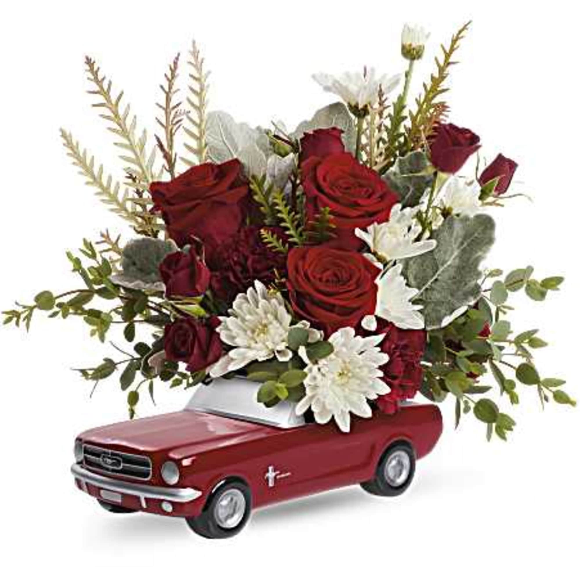 Red rose arrangement in a red toy car container