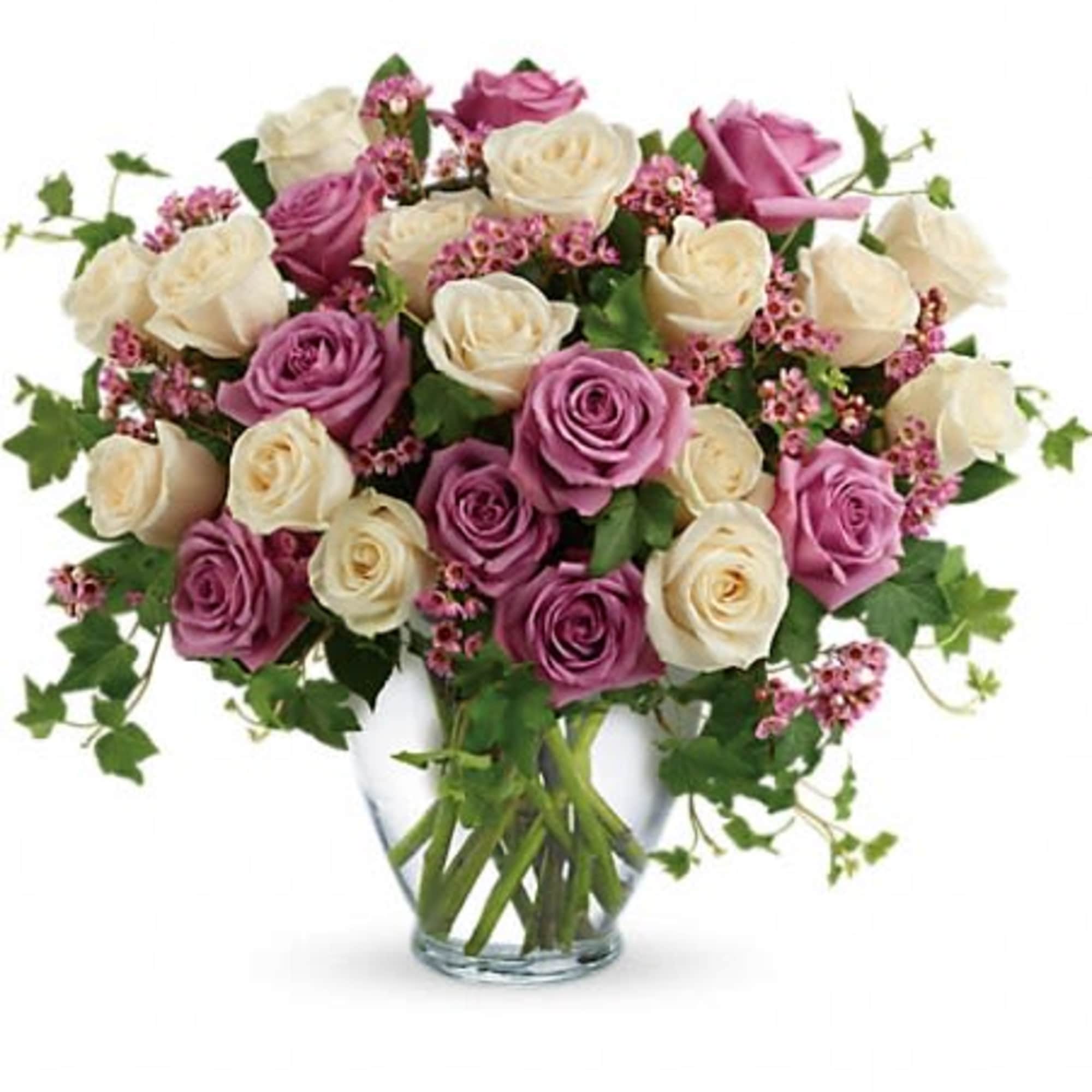 Pink and cream roses in a clear glass vase
