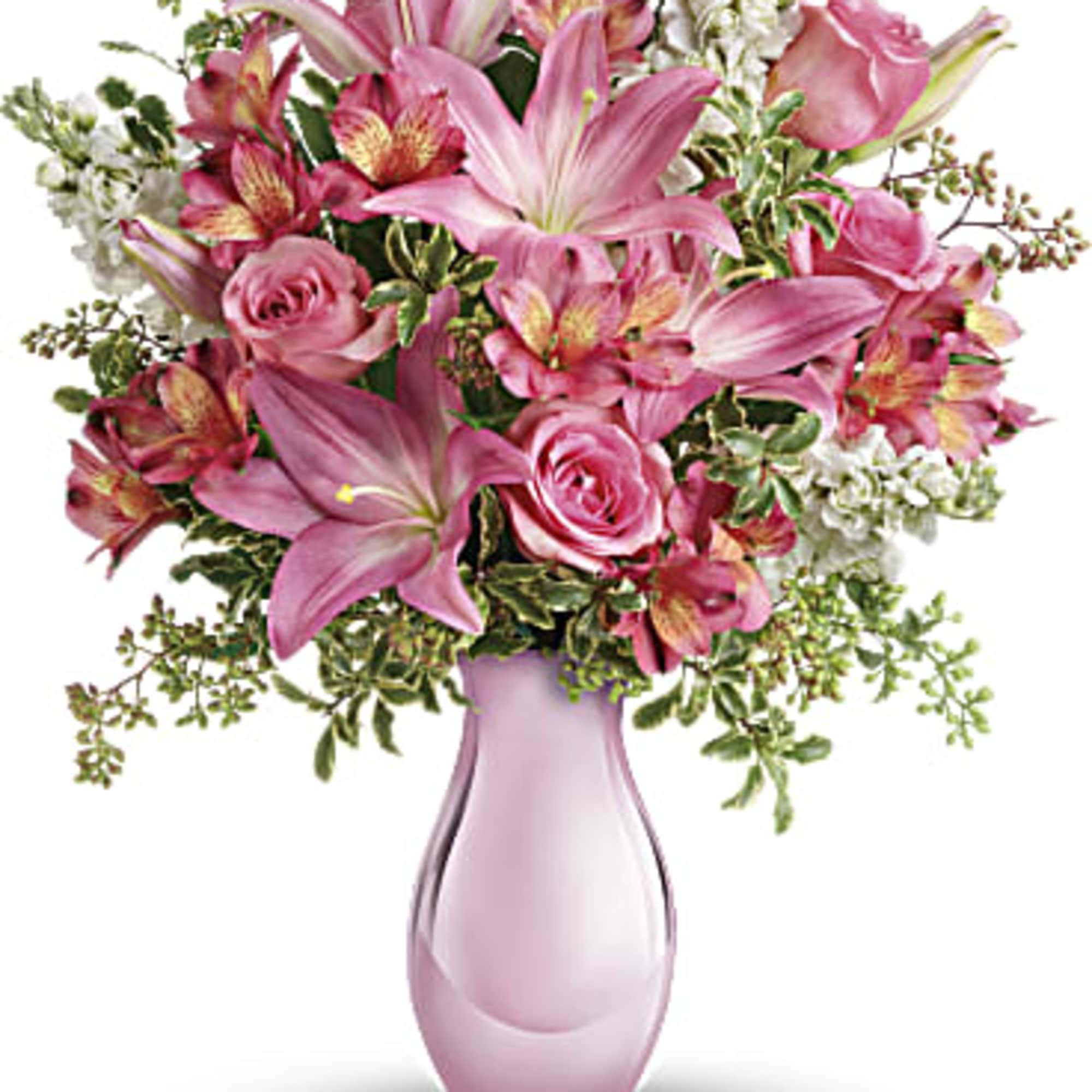 Pink lilies and roses in a pink glass vase