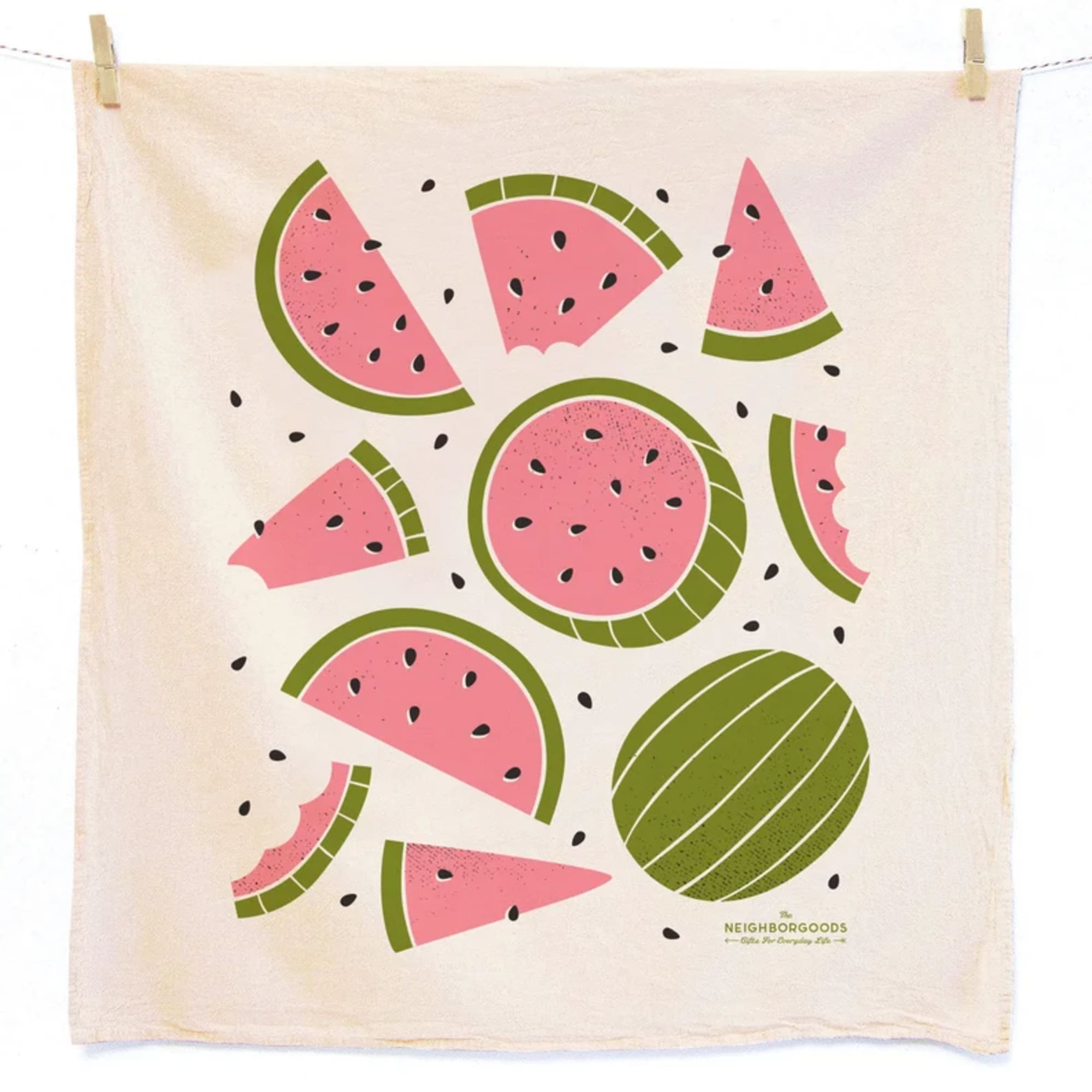 Cream tea towel with graphic pink and green watermelon slices hanging by clothespins