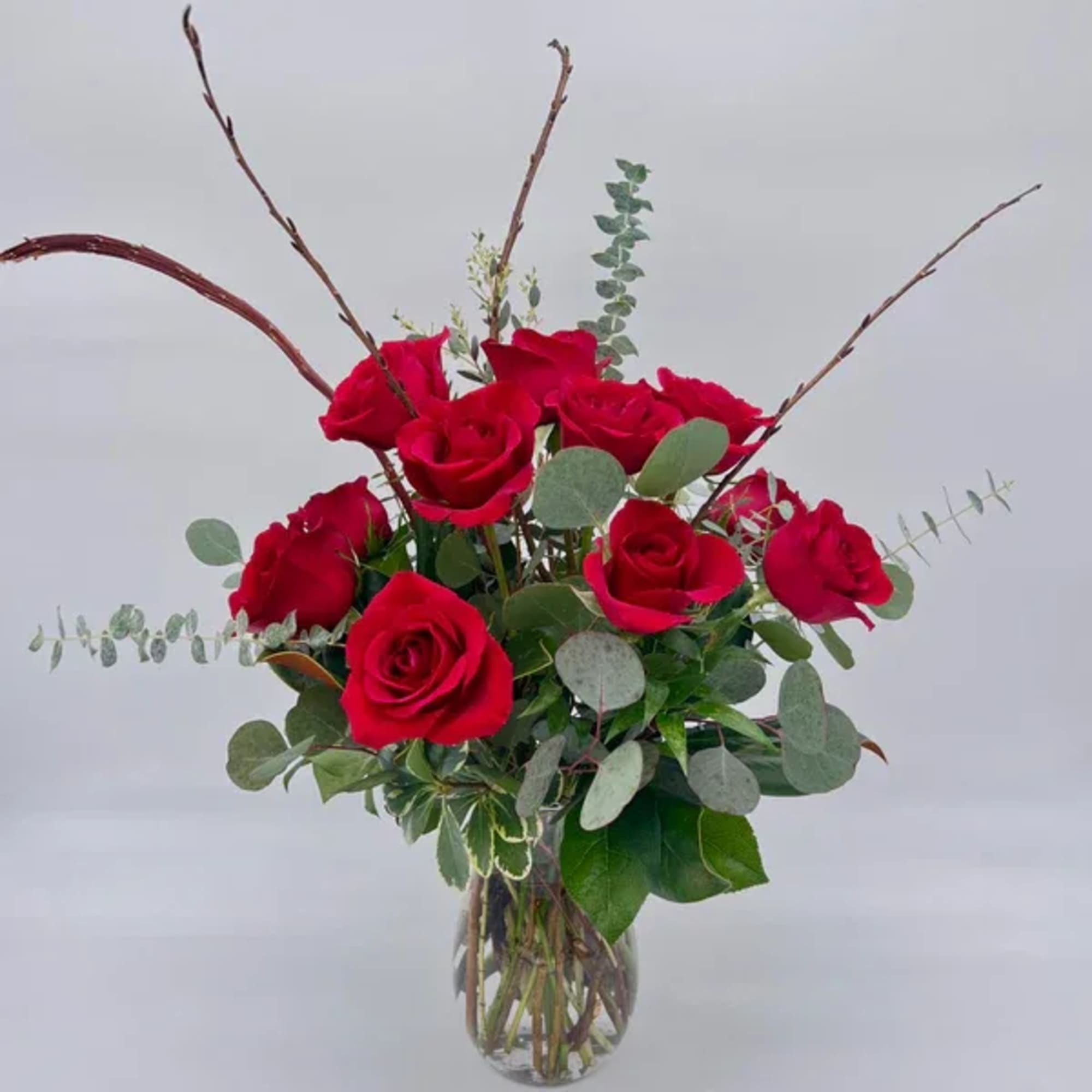 Arrangement of red roses in a clear glass vase