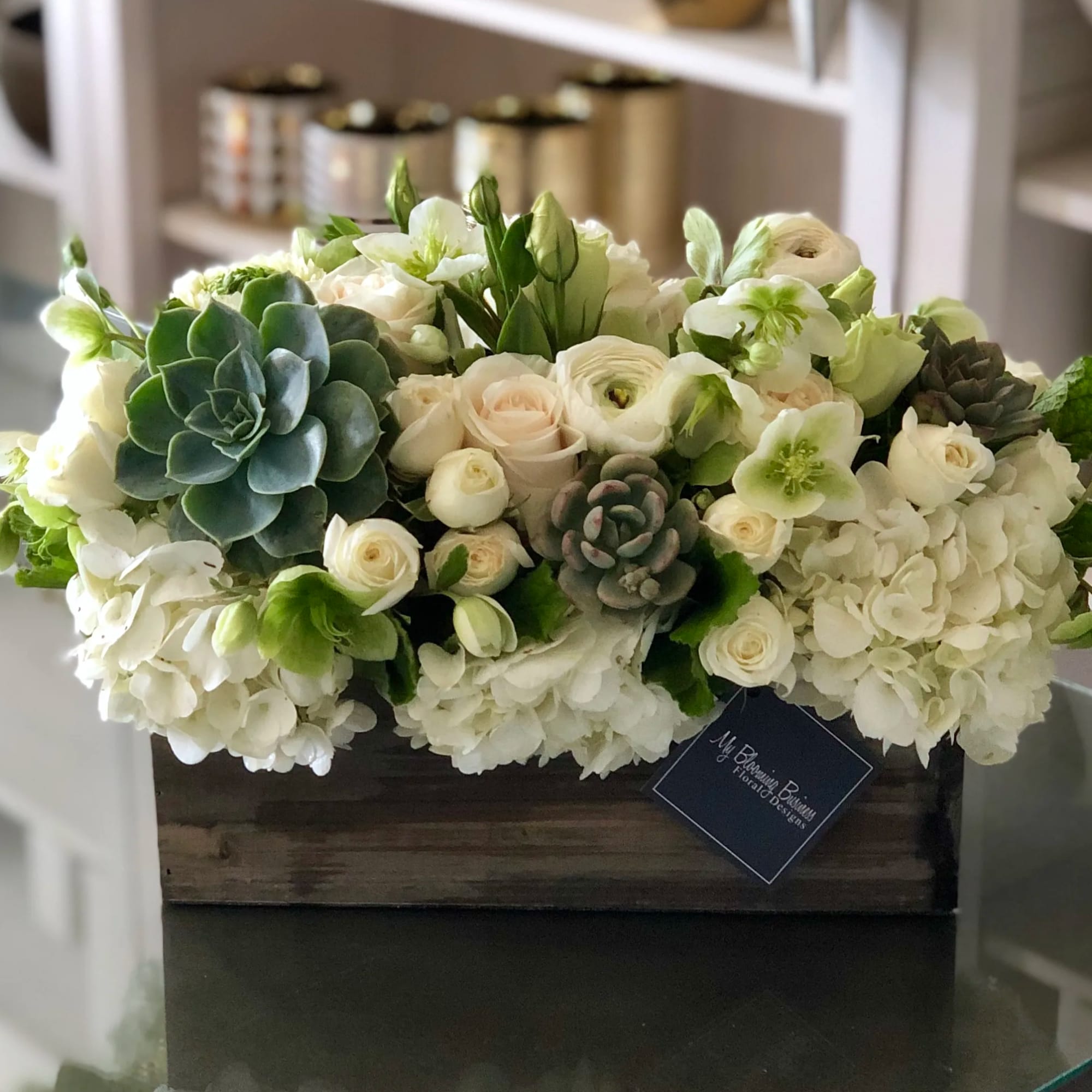 White floral arrangement with succulents in a wooden box, photo 2 of 2