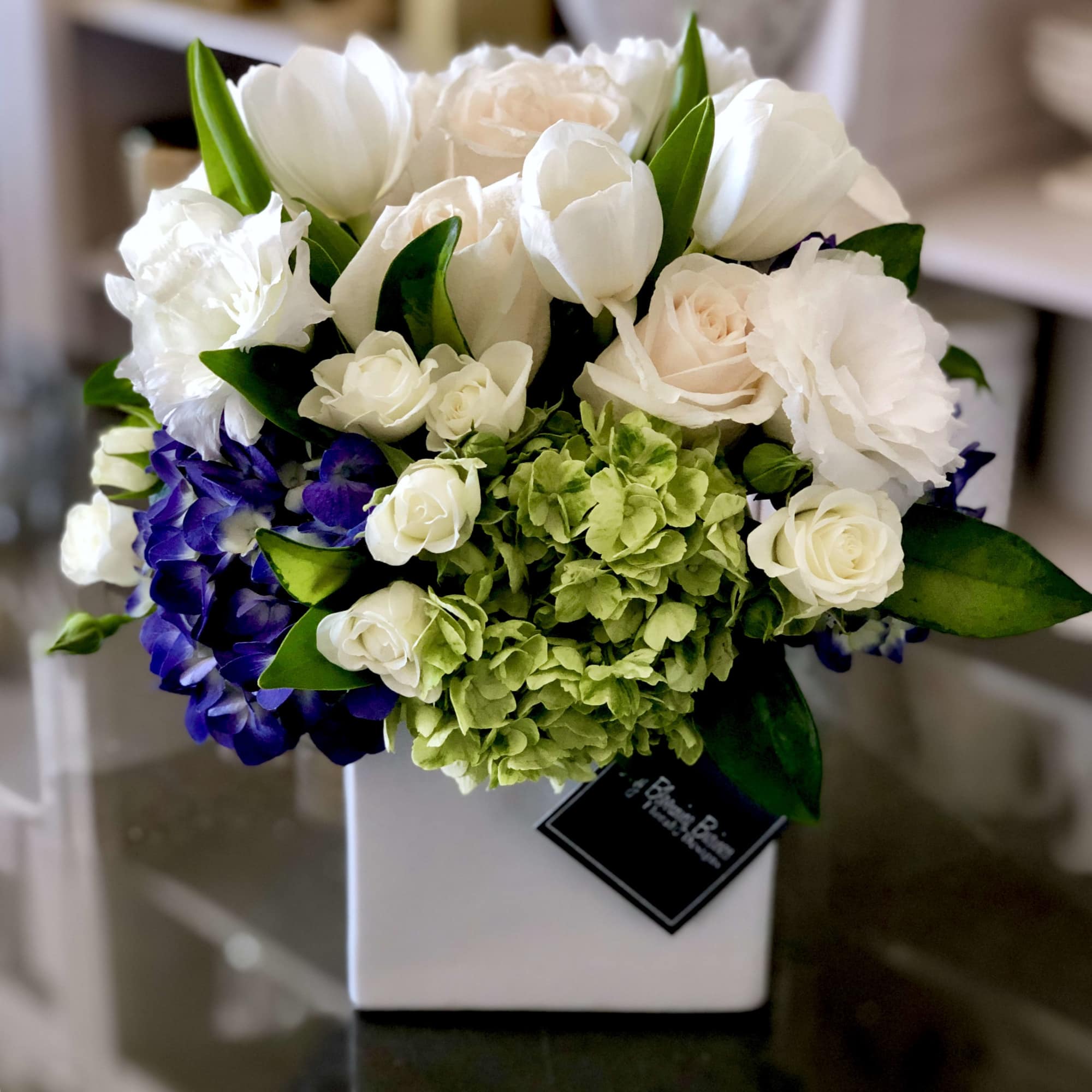 Bouquet of white and pale pink flowers in a white vase