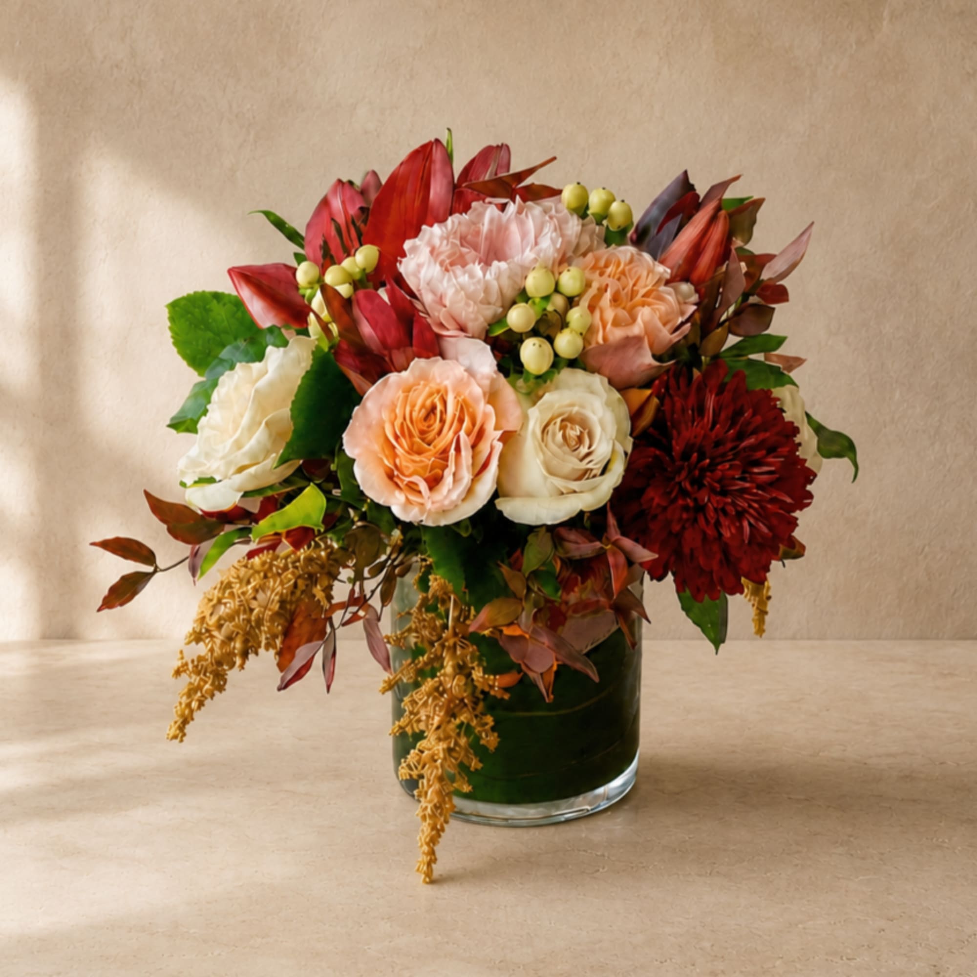 Mixed bouquet of roses and mums in a glass vase