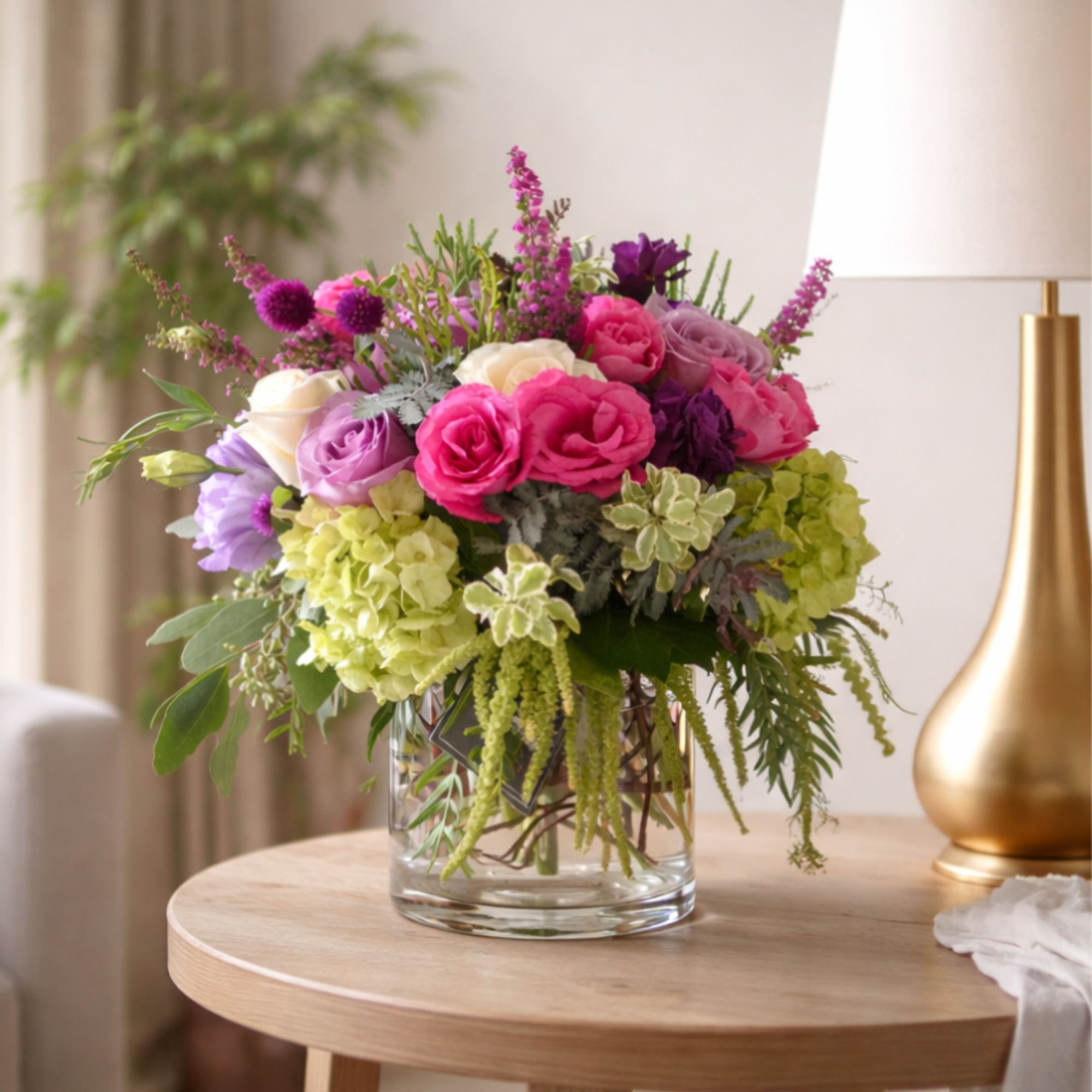 Mixed pink and purple bouquet in a clear glass vase