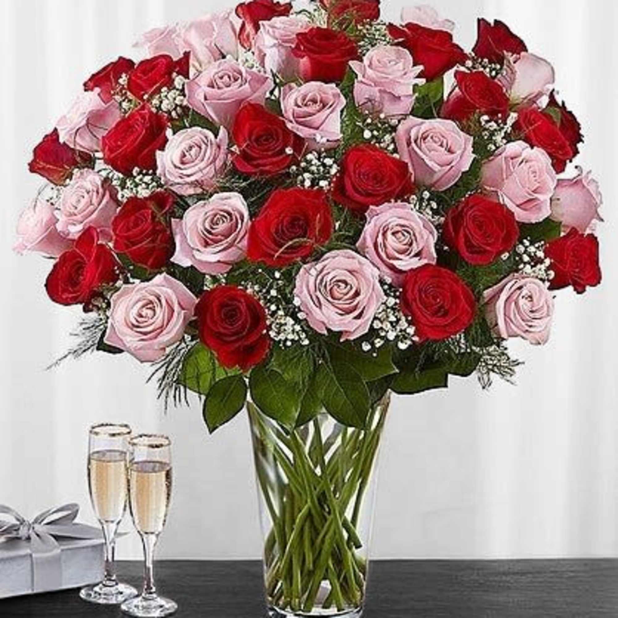 Bouquet of red and pink roses in a clear glass vase