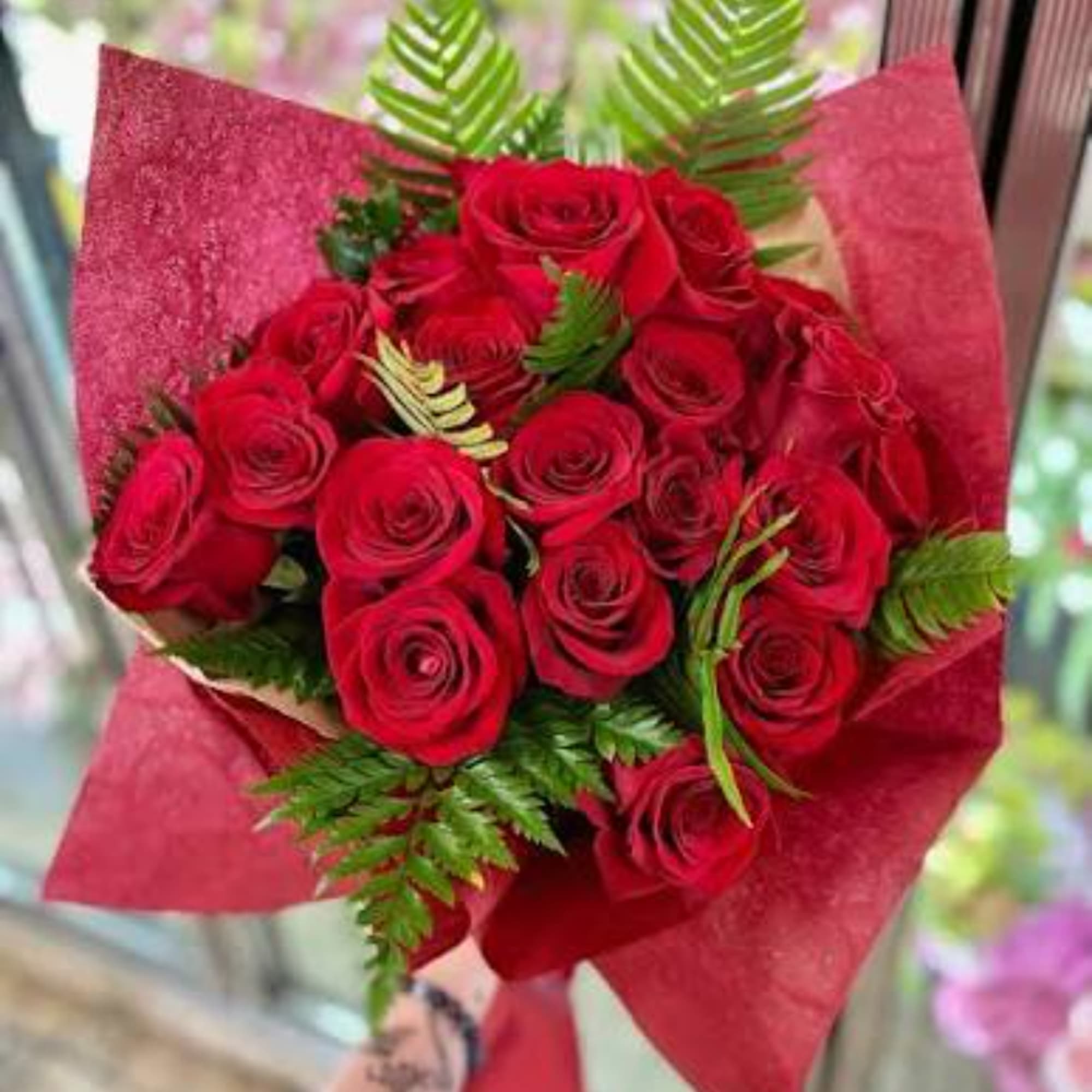 Bouquet of red roses wrapped in red paper