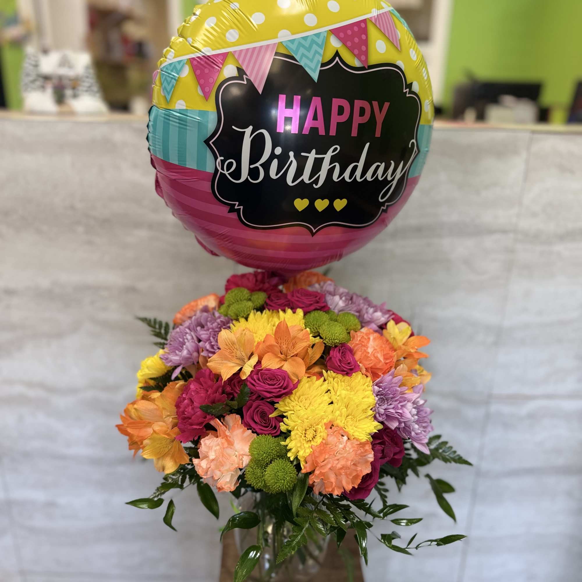 A bright, cheerful mix of colorful blooms designed to celebrate joy, happiness