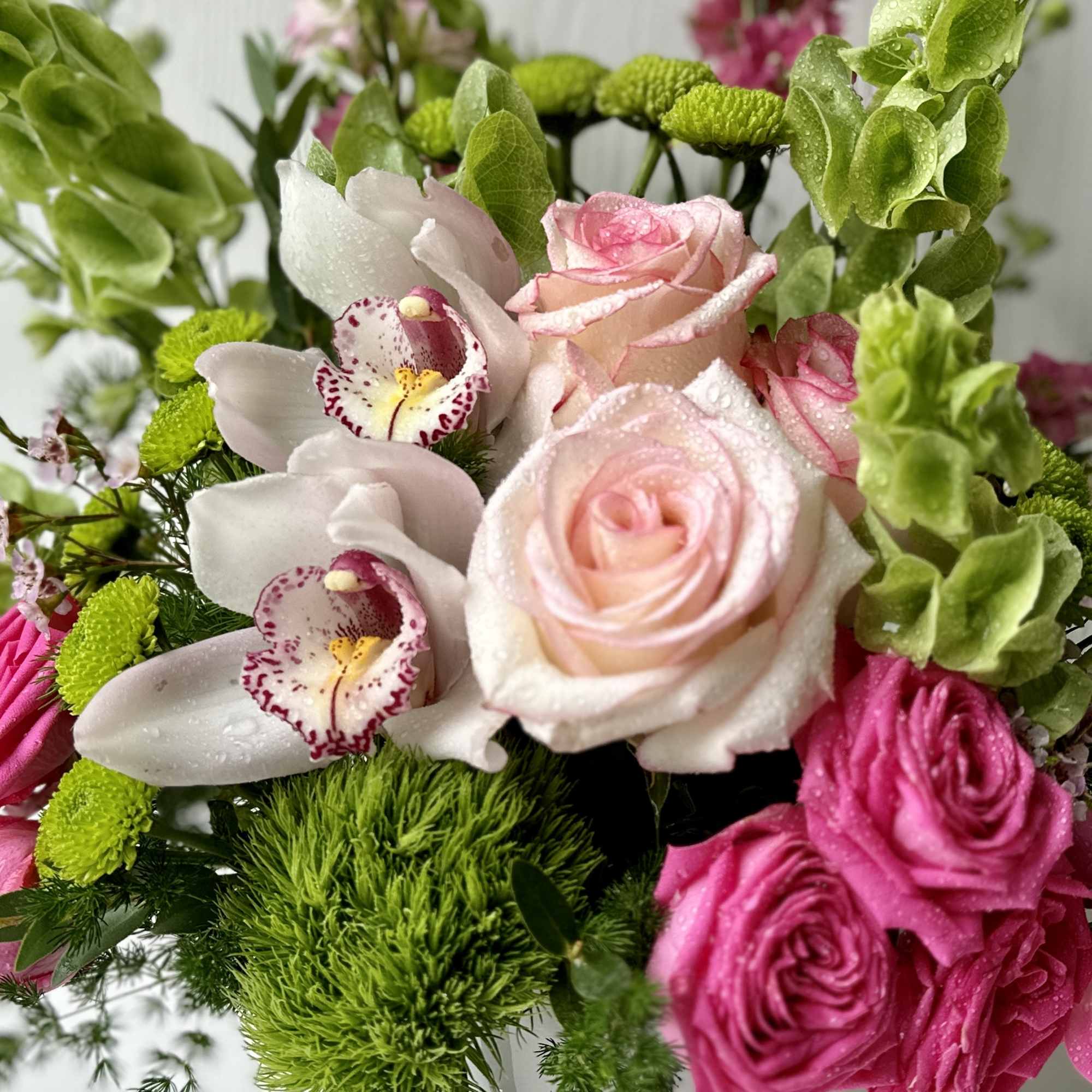A cheerful blend of pinks and fresh greens, this flower arrangement is, photo 2 of 2