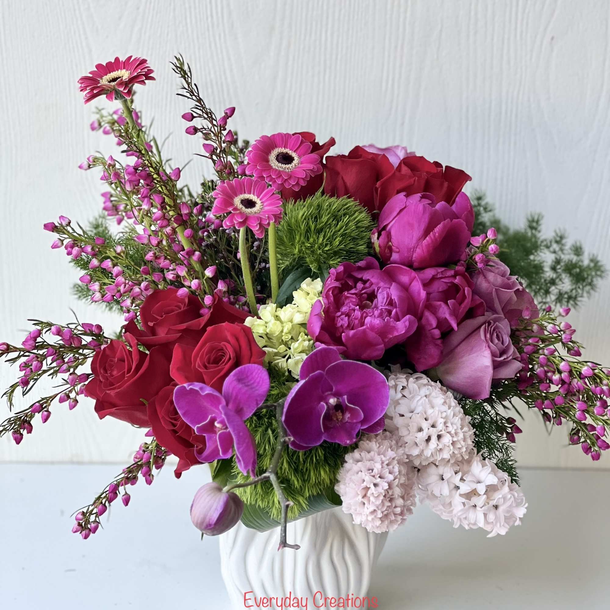 Bouquet of pink and red flowers in a white vase