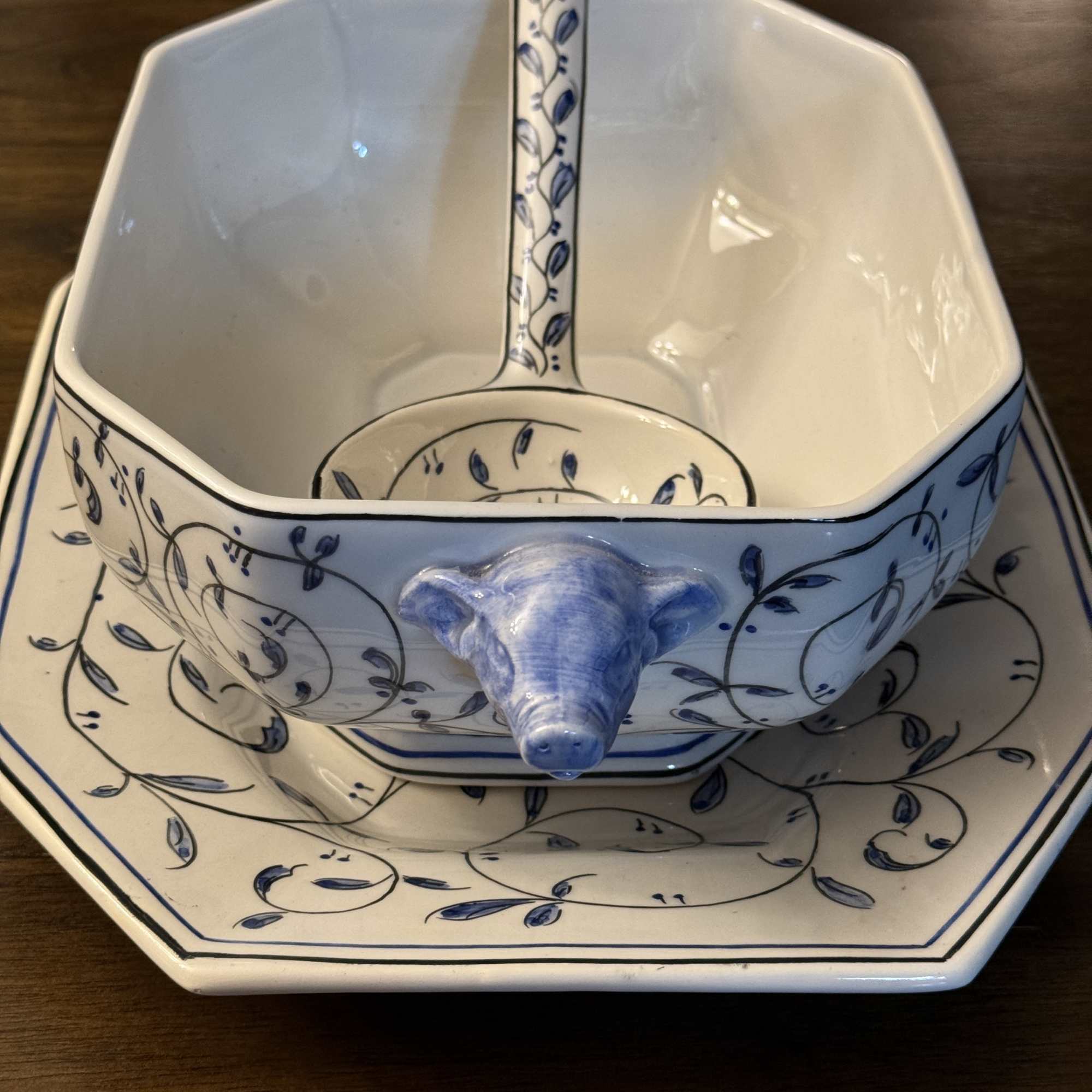 Blue-and-white ceramic serving bowl with a matching ladle and tray