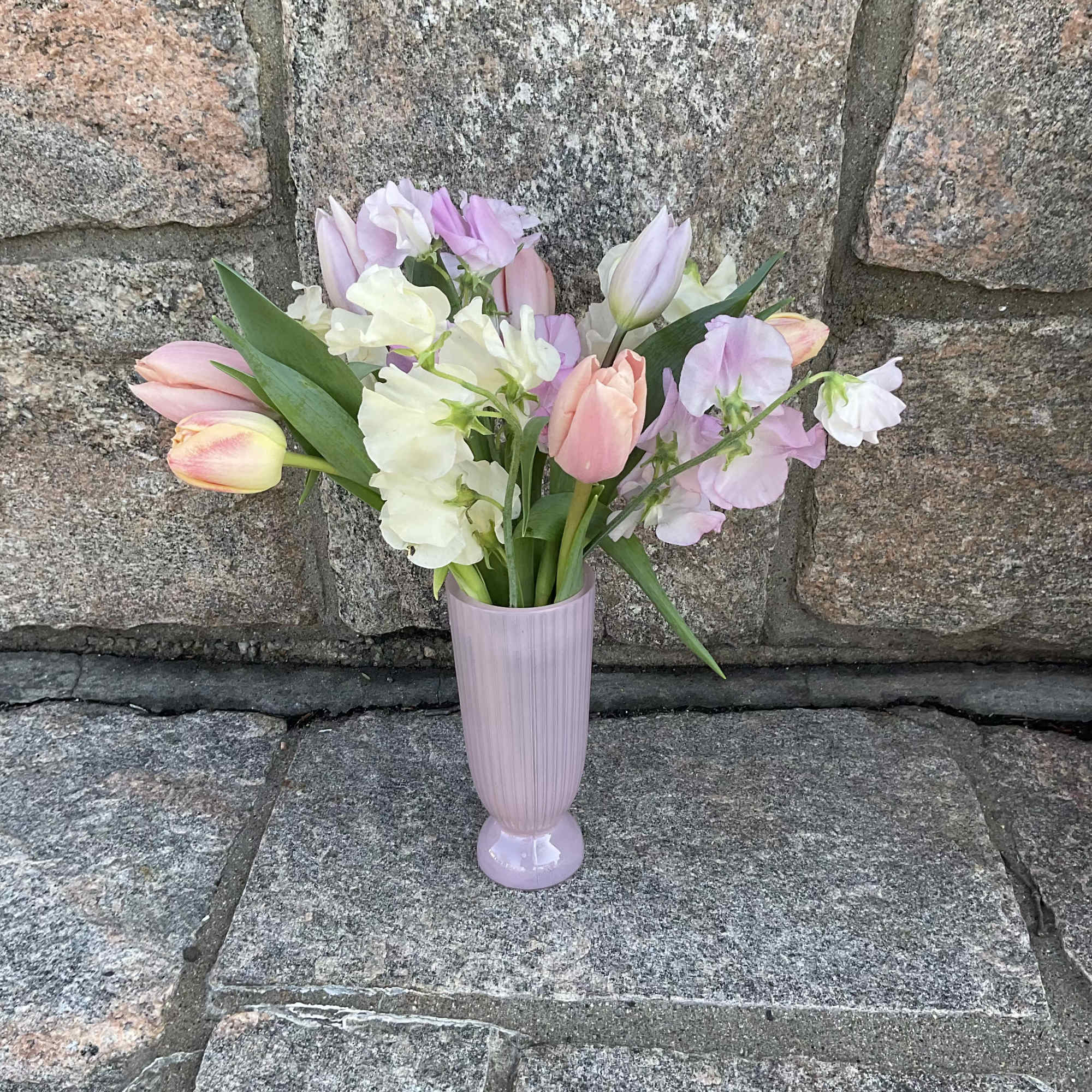 Pastel tulips and sweet peas in a lavender vase
