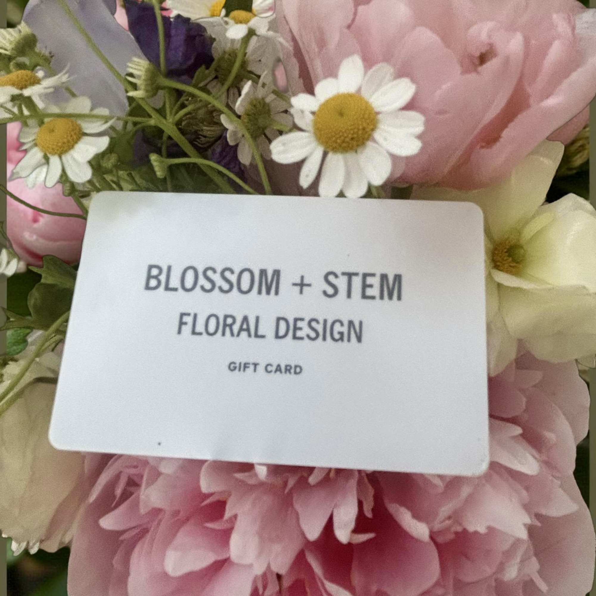 Pink and white flowers with a gift card in the center