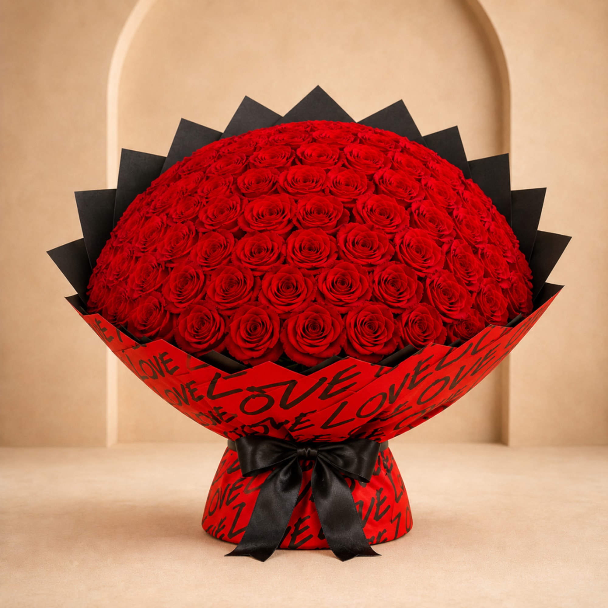 Large bouquet of red roses wrapped in red and black paper with a black ribbon