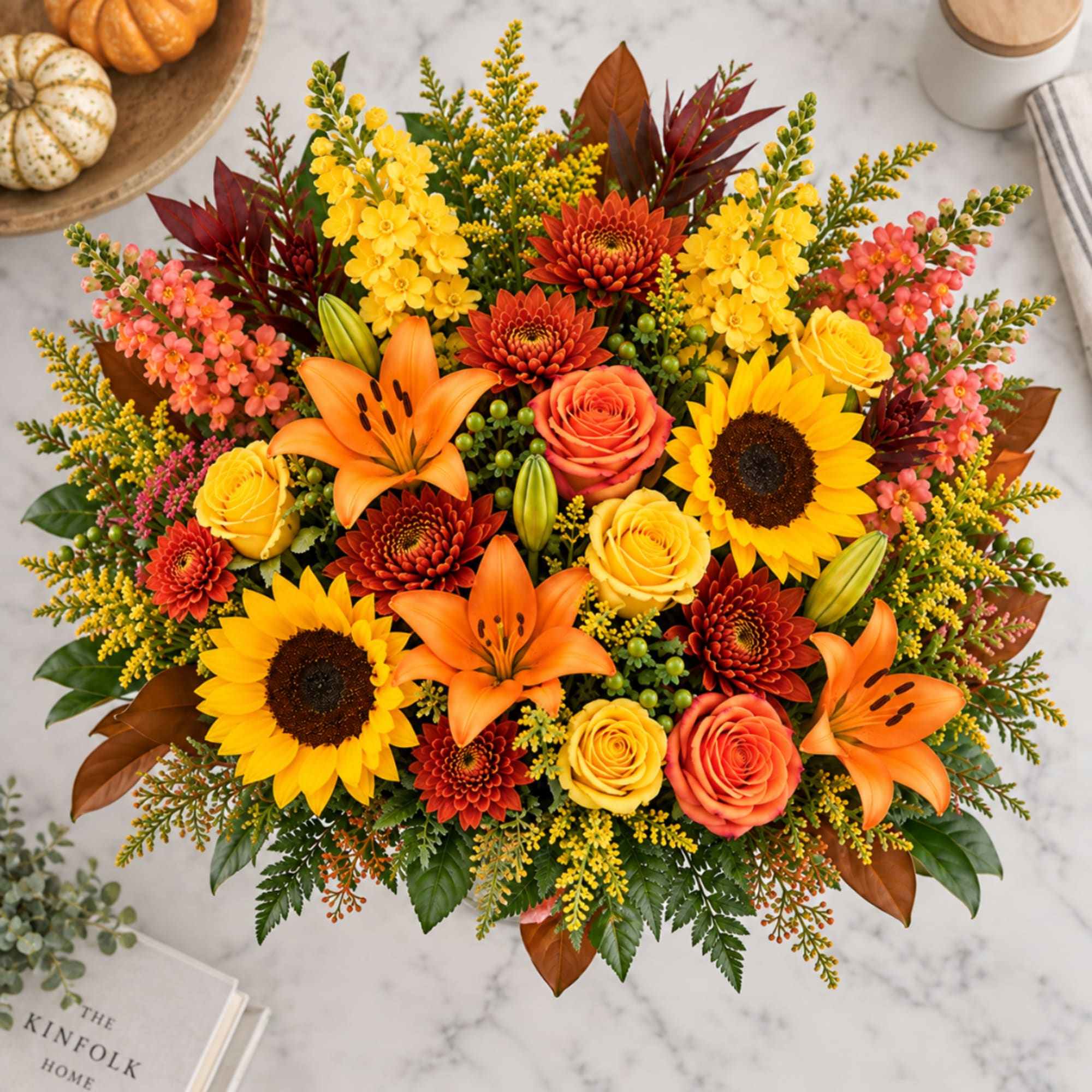 Bright bouquet with sunflowers, orange lilies, and roses in autumn colors