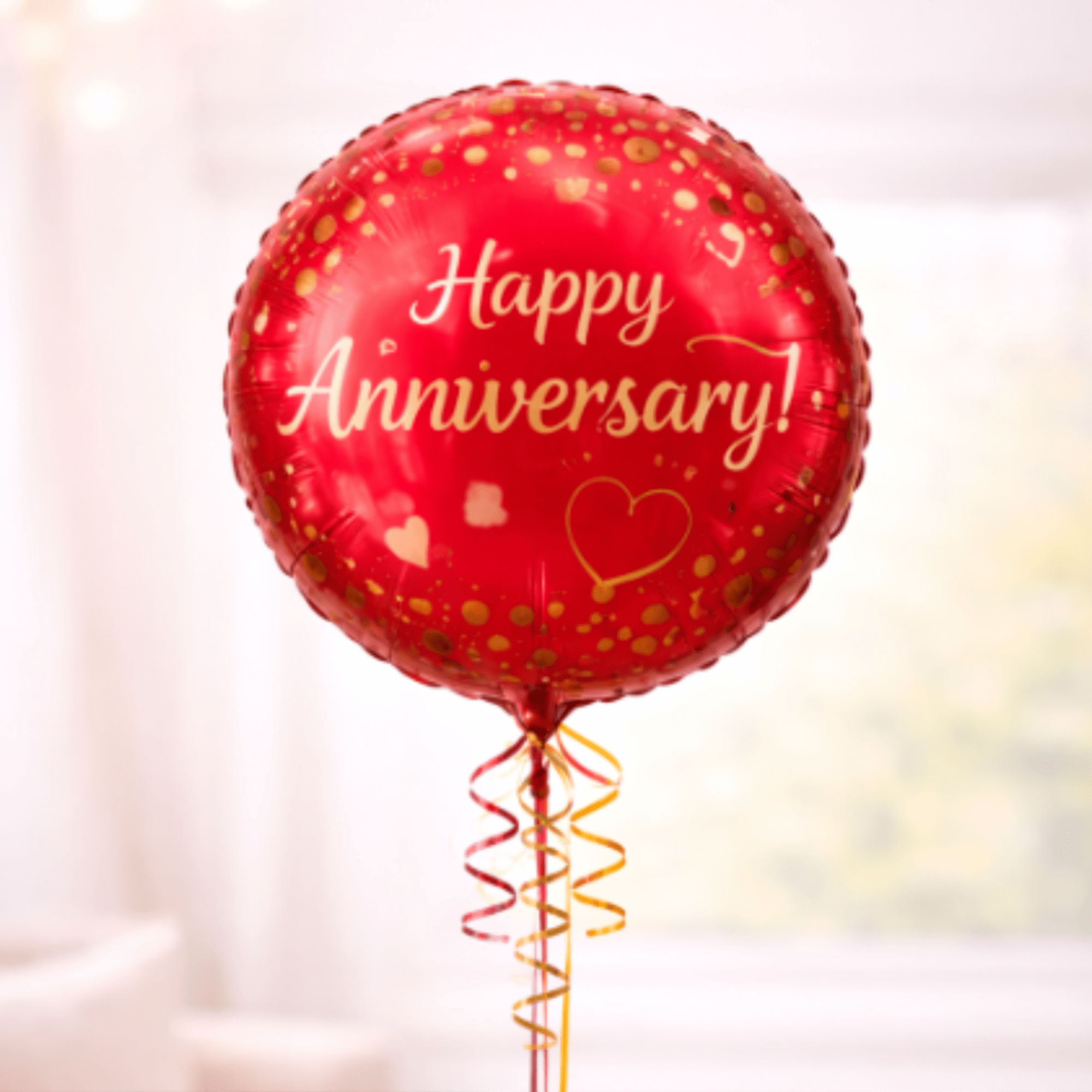 Red anniversary balloon with gold confetti and ribbon curls