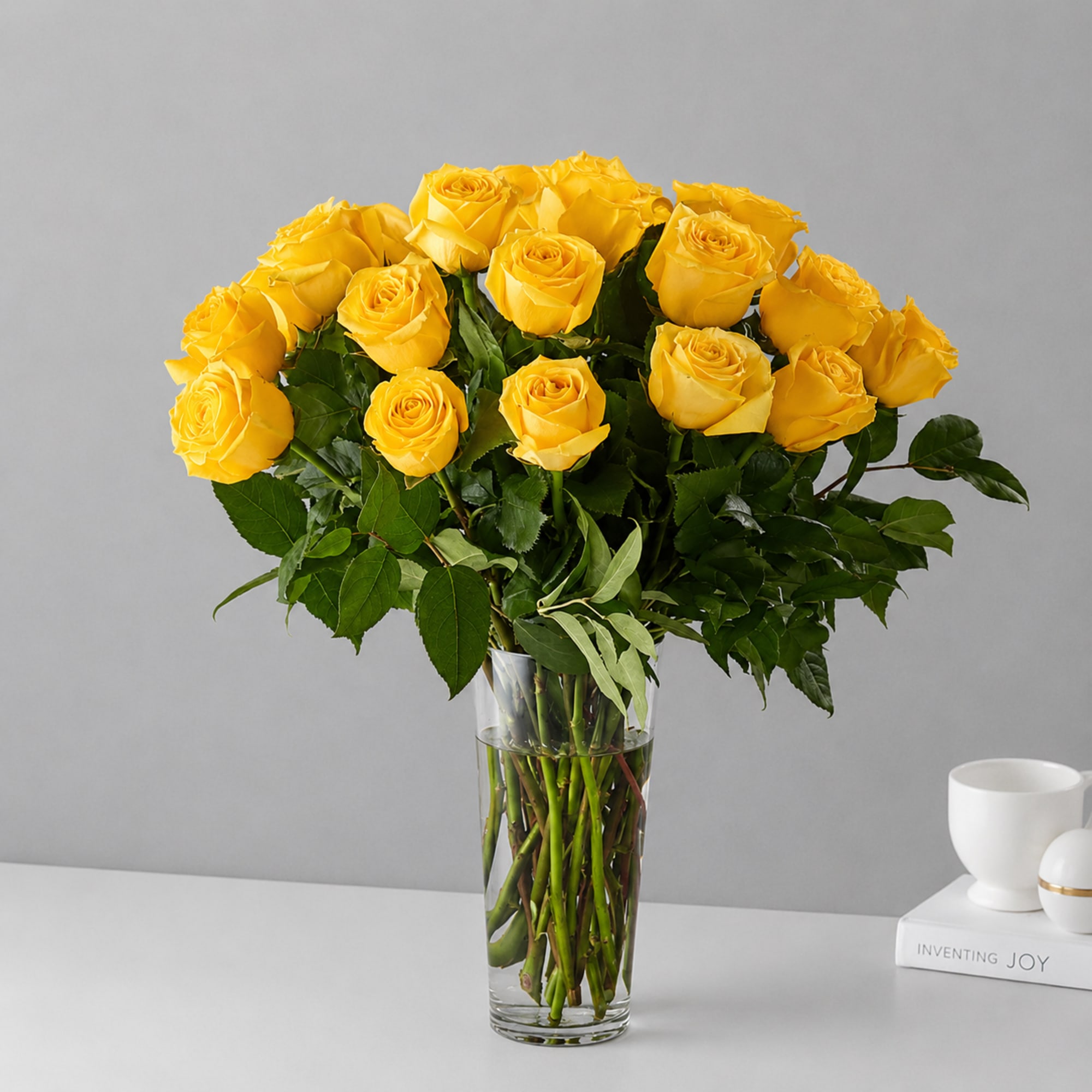 A radiant cluster of bright yellow roses gives this flower arrangement a