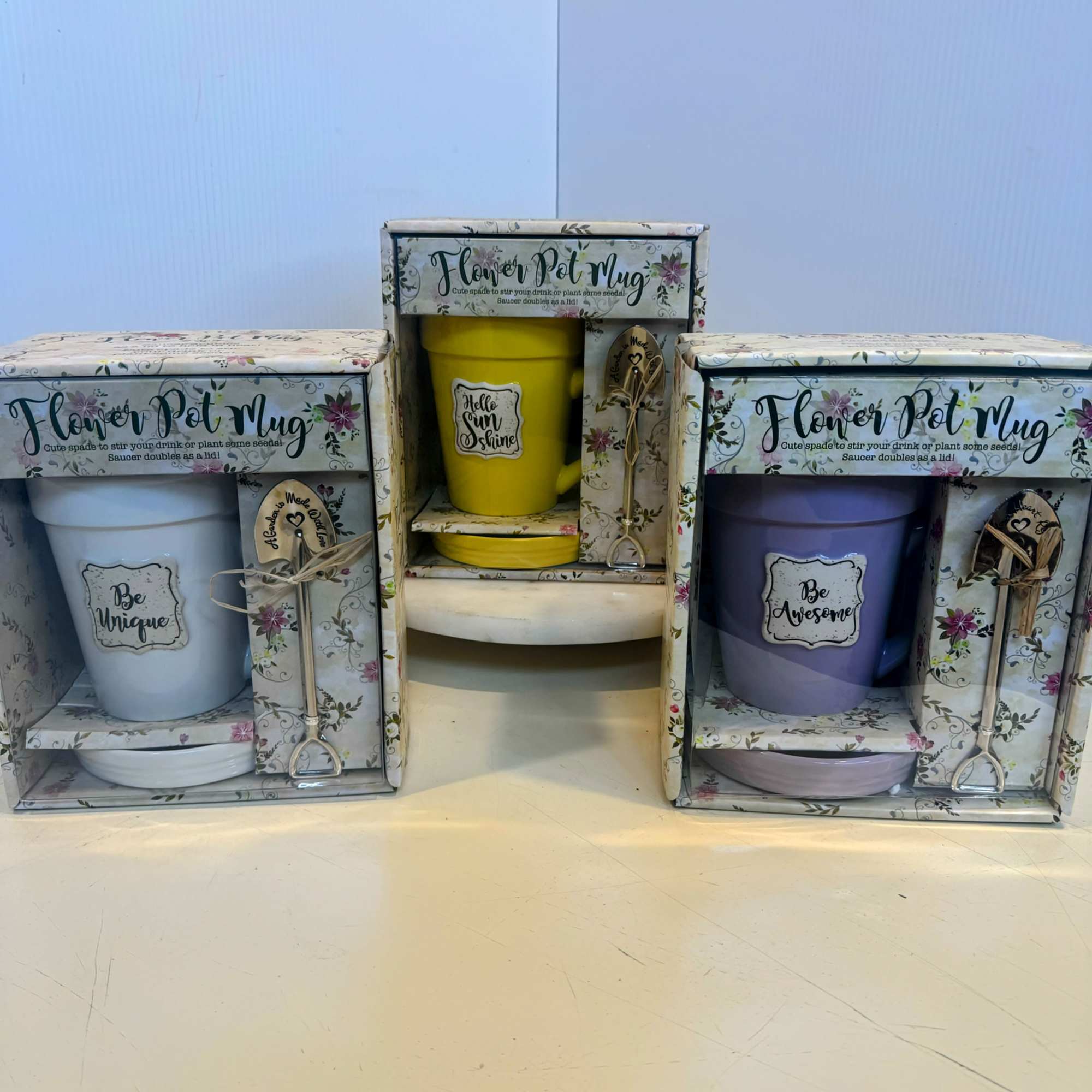 Three boxed flower pot mug gift sets with colorful mugs and matching saucers