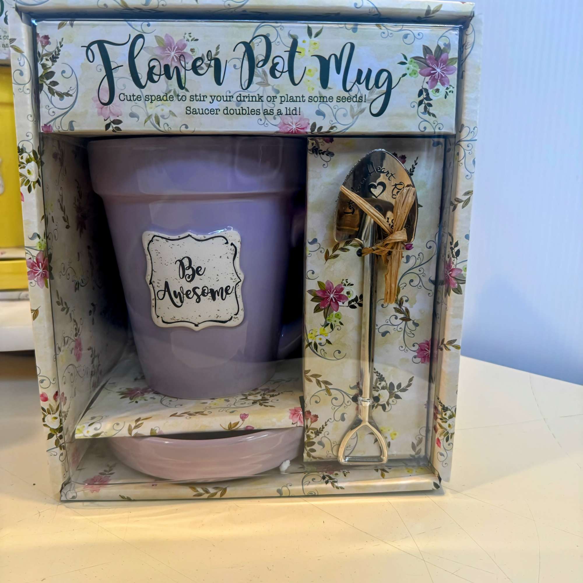 Gift set with a lavender flower pot, saucer, and small shovel in a floral box