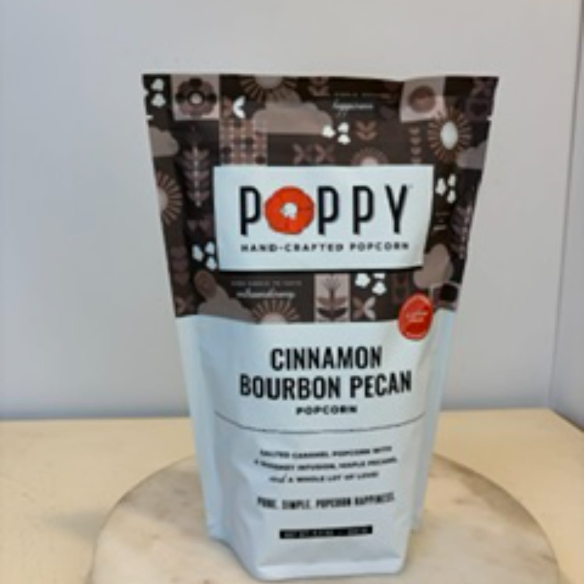 Bag of Poppy cinnamon bourbon pecan popcorn on a table