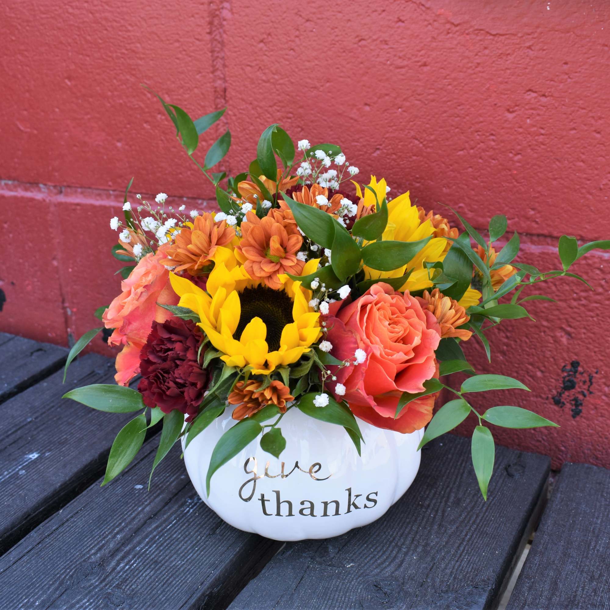 Bright sunflowers, orange roses, mums and carnations are designed in a white, photo 2 of 2