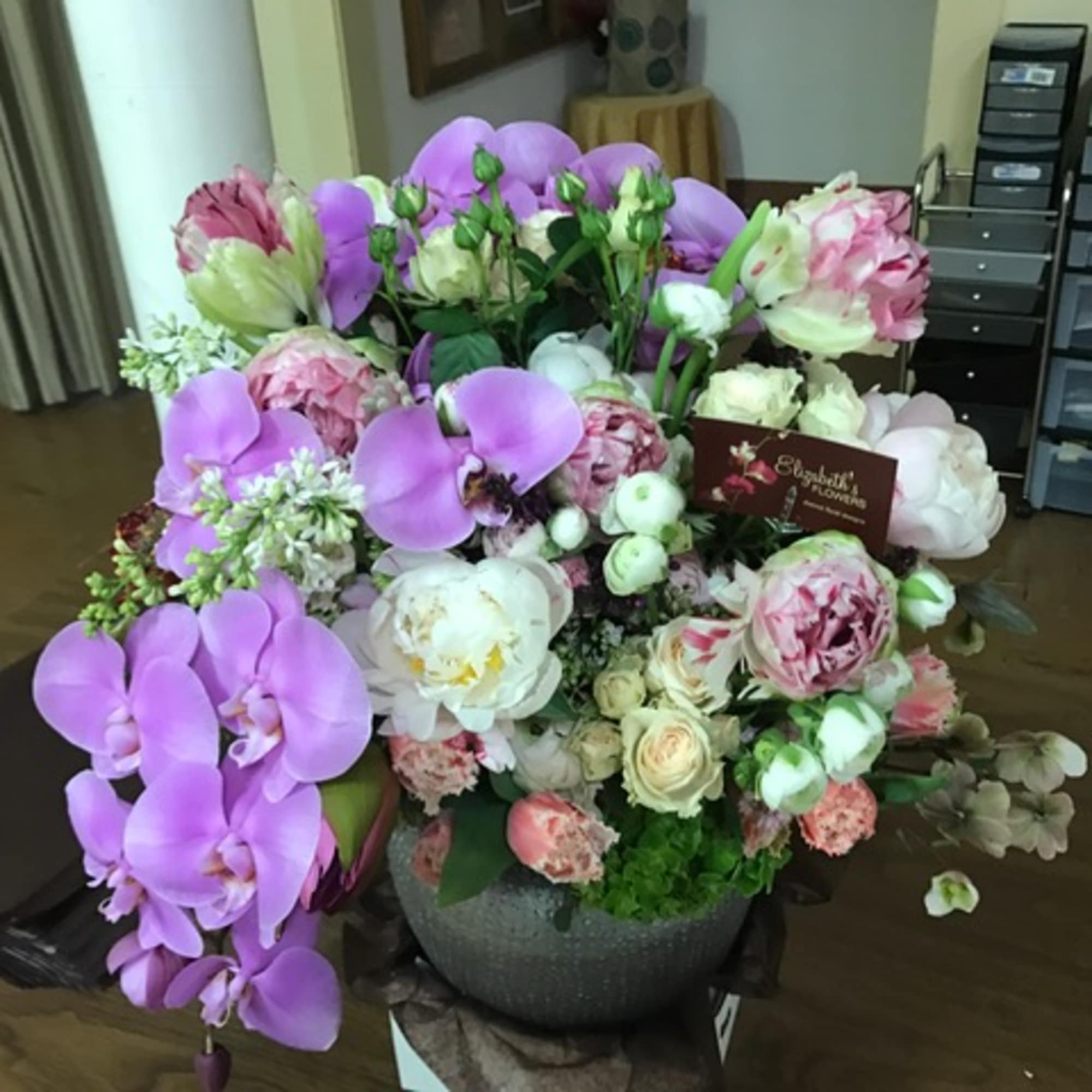 A lush, artful and grand mix of high-end seasonal flowers in pastel