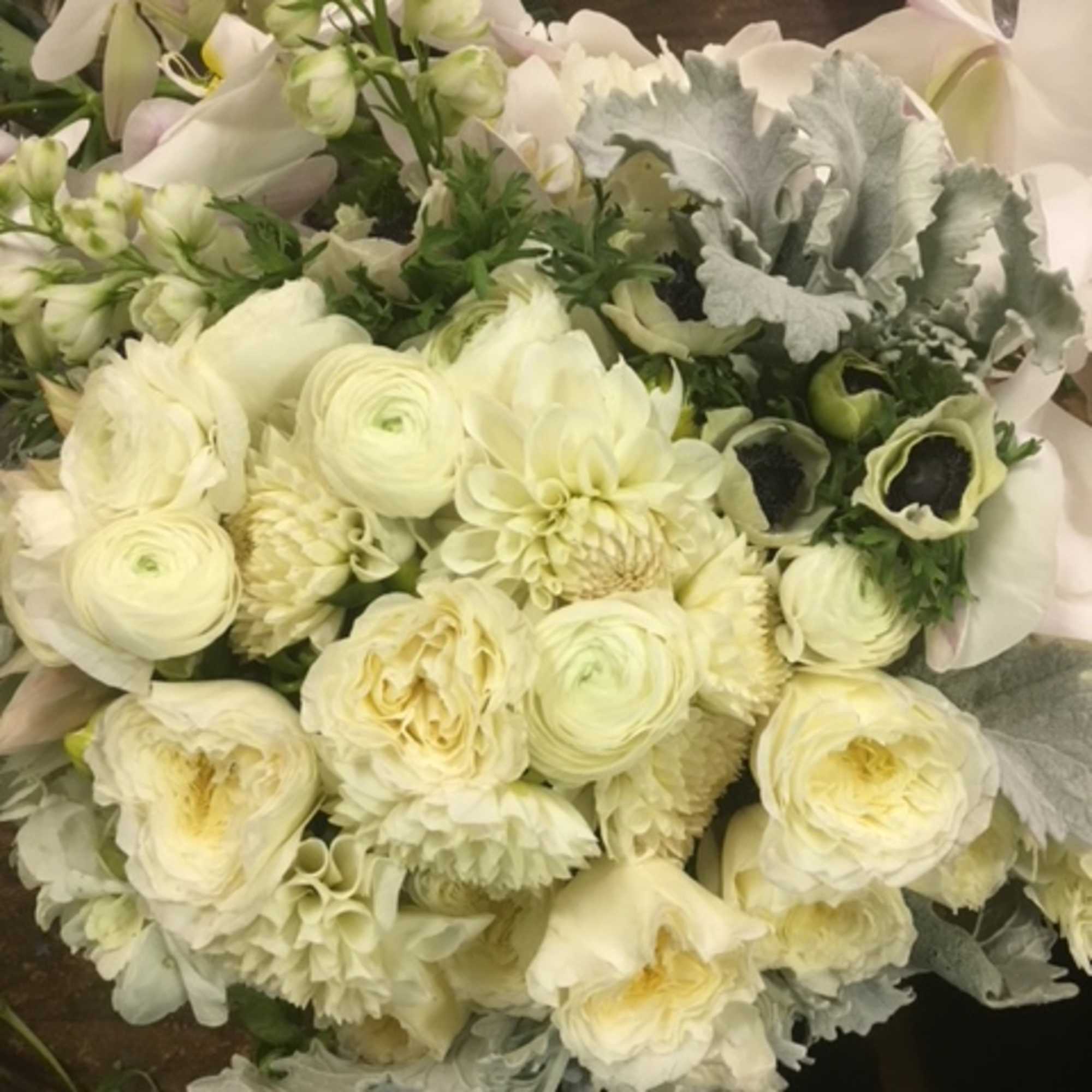 Sophisticated medley in white and silver hues, presented in a 8"x8" clear