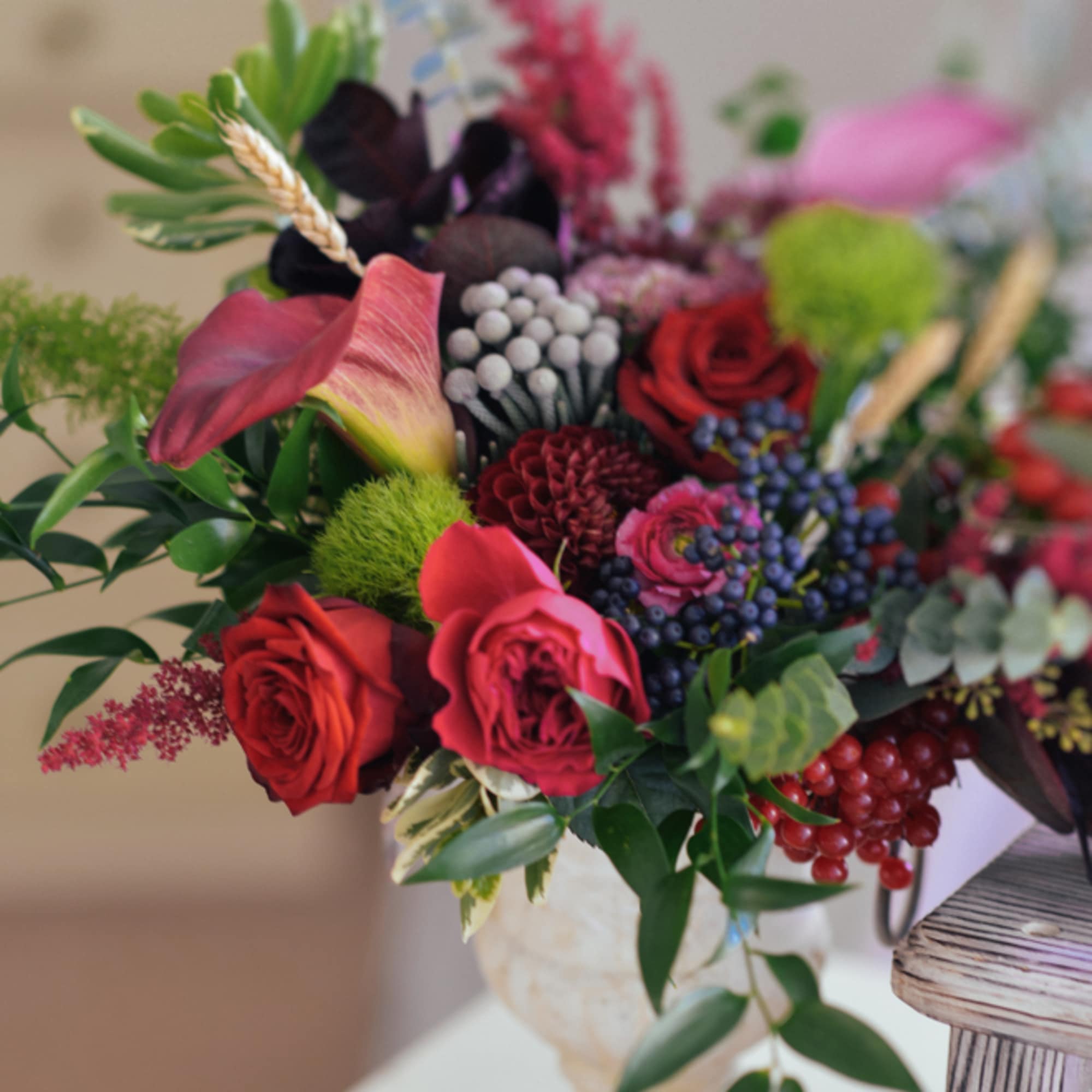Mixed bouquet with red roses and pink calla lilies in a vase