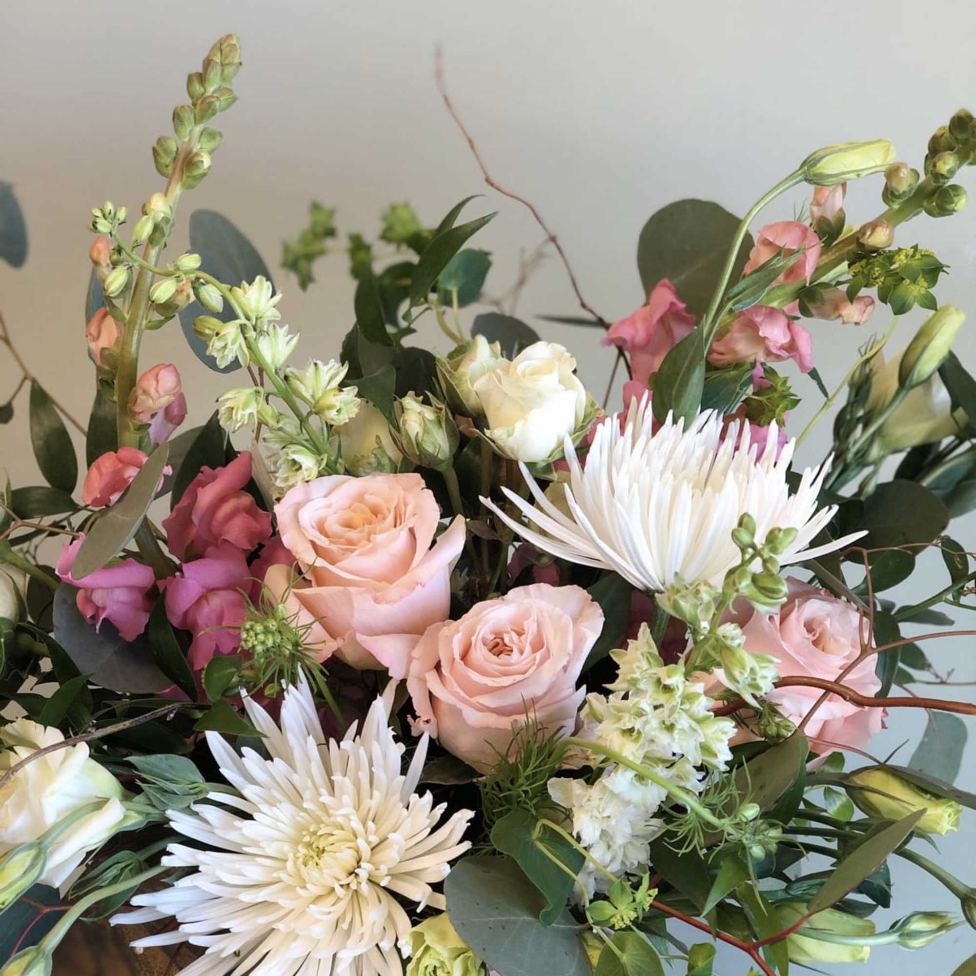 Bouquet of pale pink roses and white spider mums with greenery