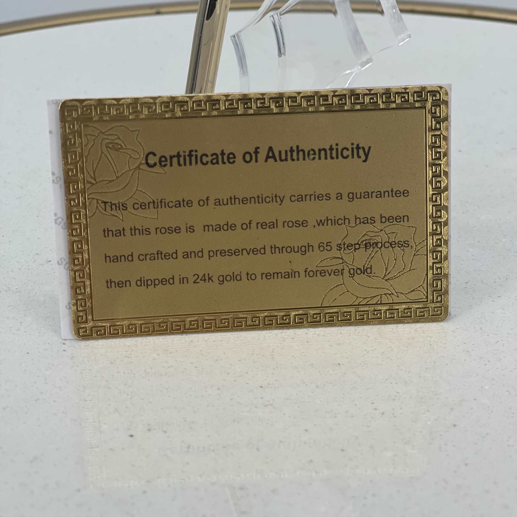 Gold certificate card for a preserved rose